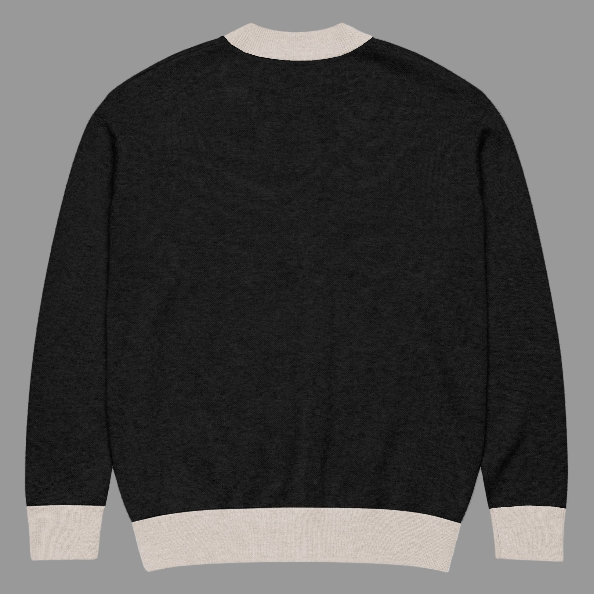 Black sweater with beige trim on a white background