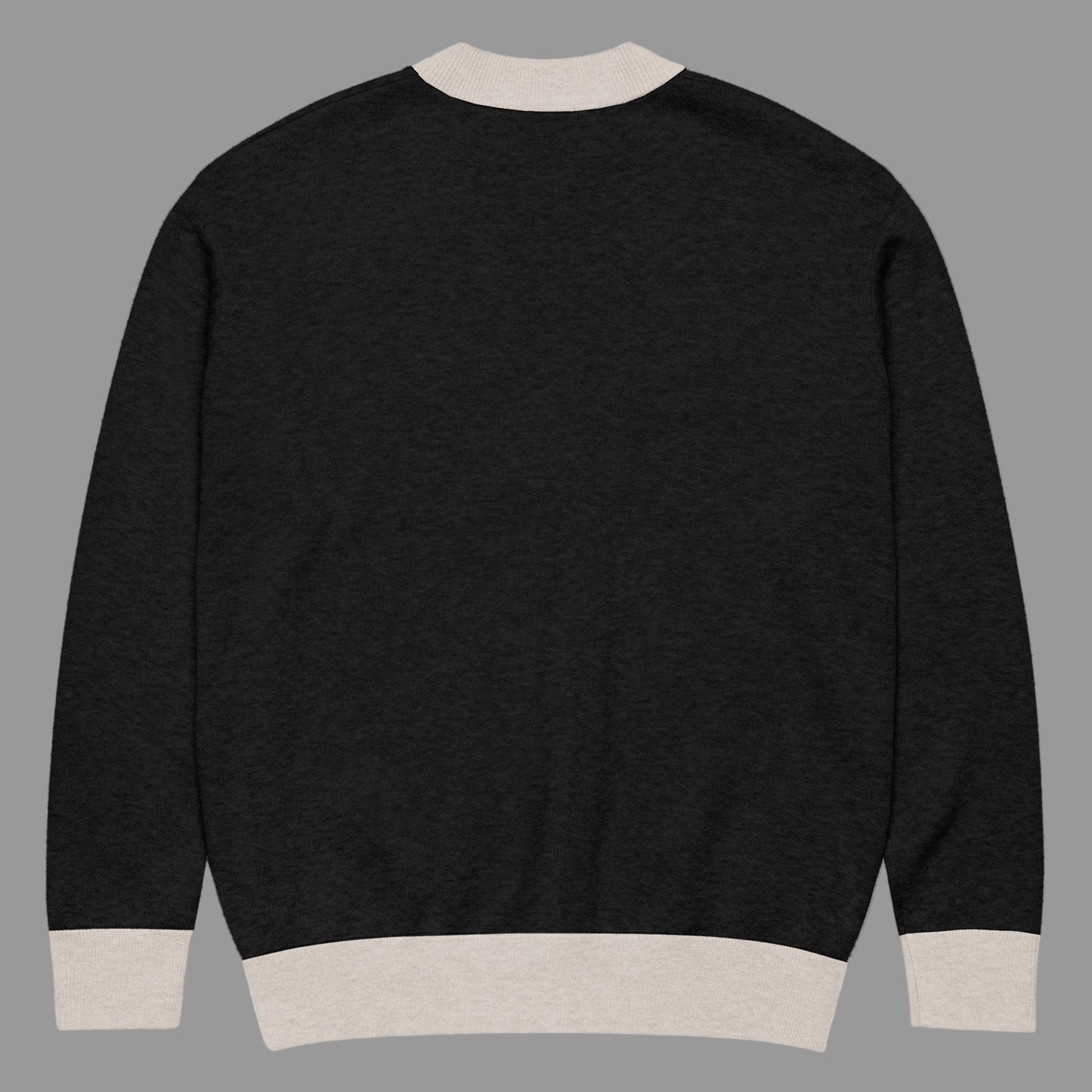 Black sweater with beige trim on a white background