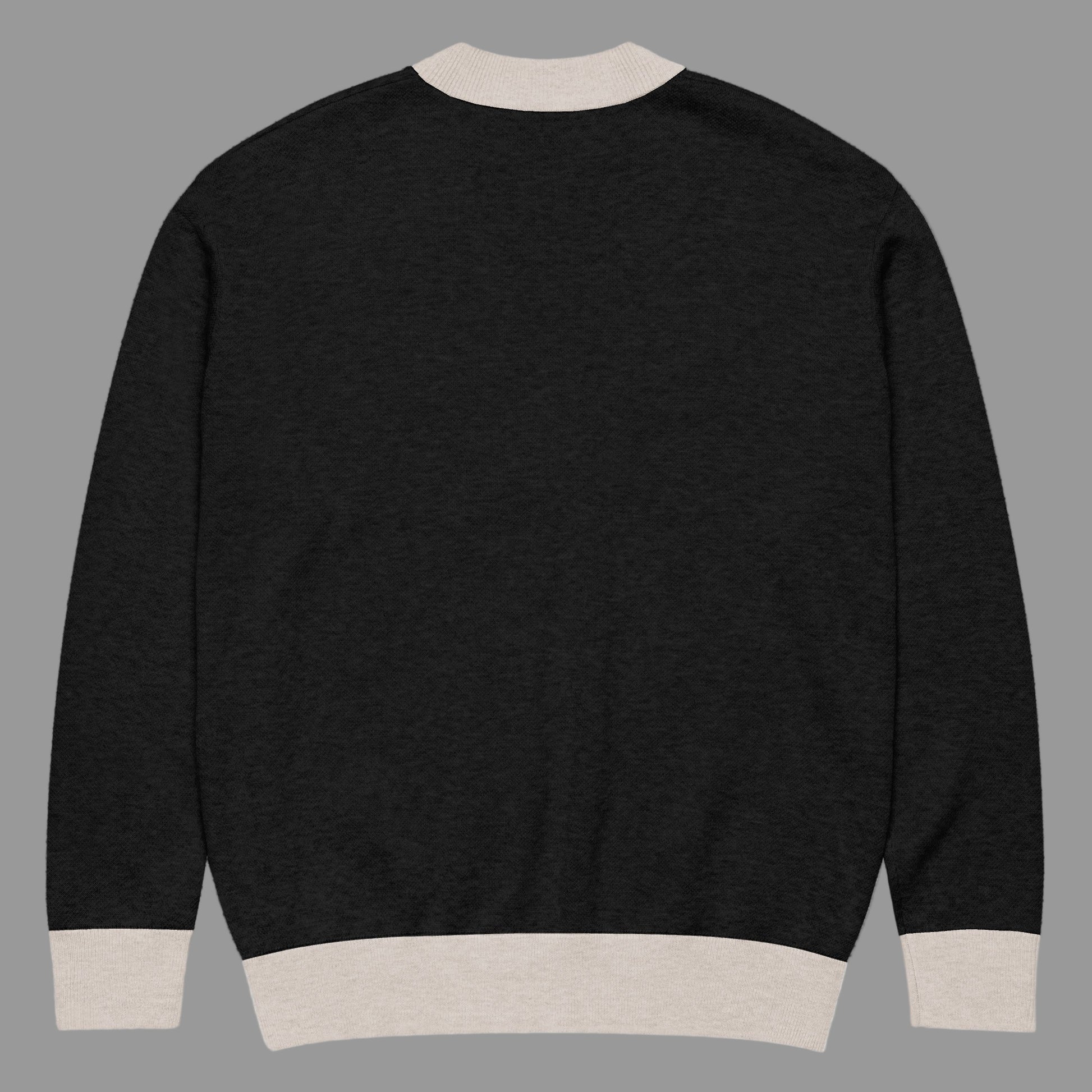 Black sweater with beige trim on a white background
