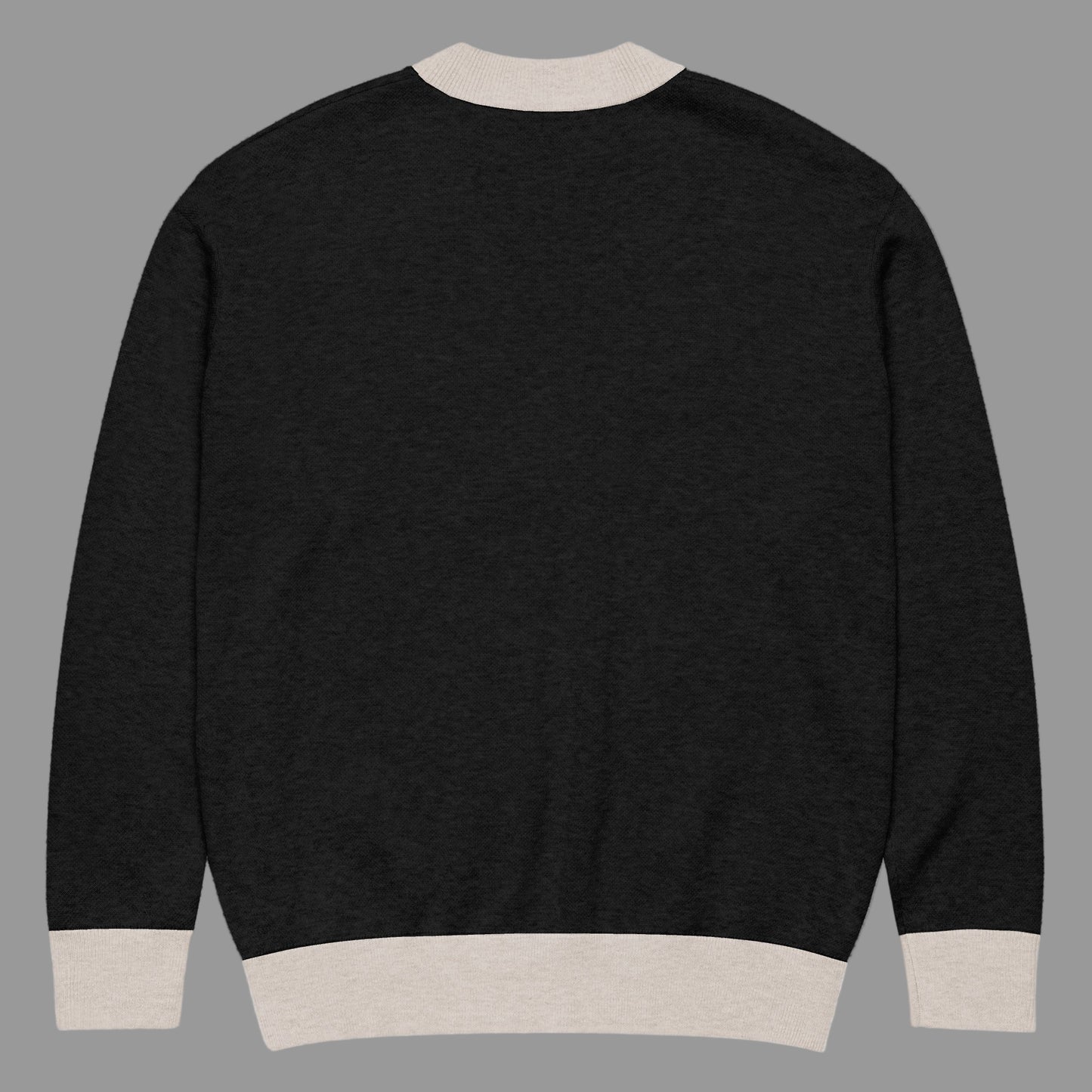Black sweater with beige trim on a white background