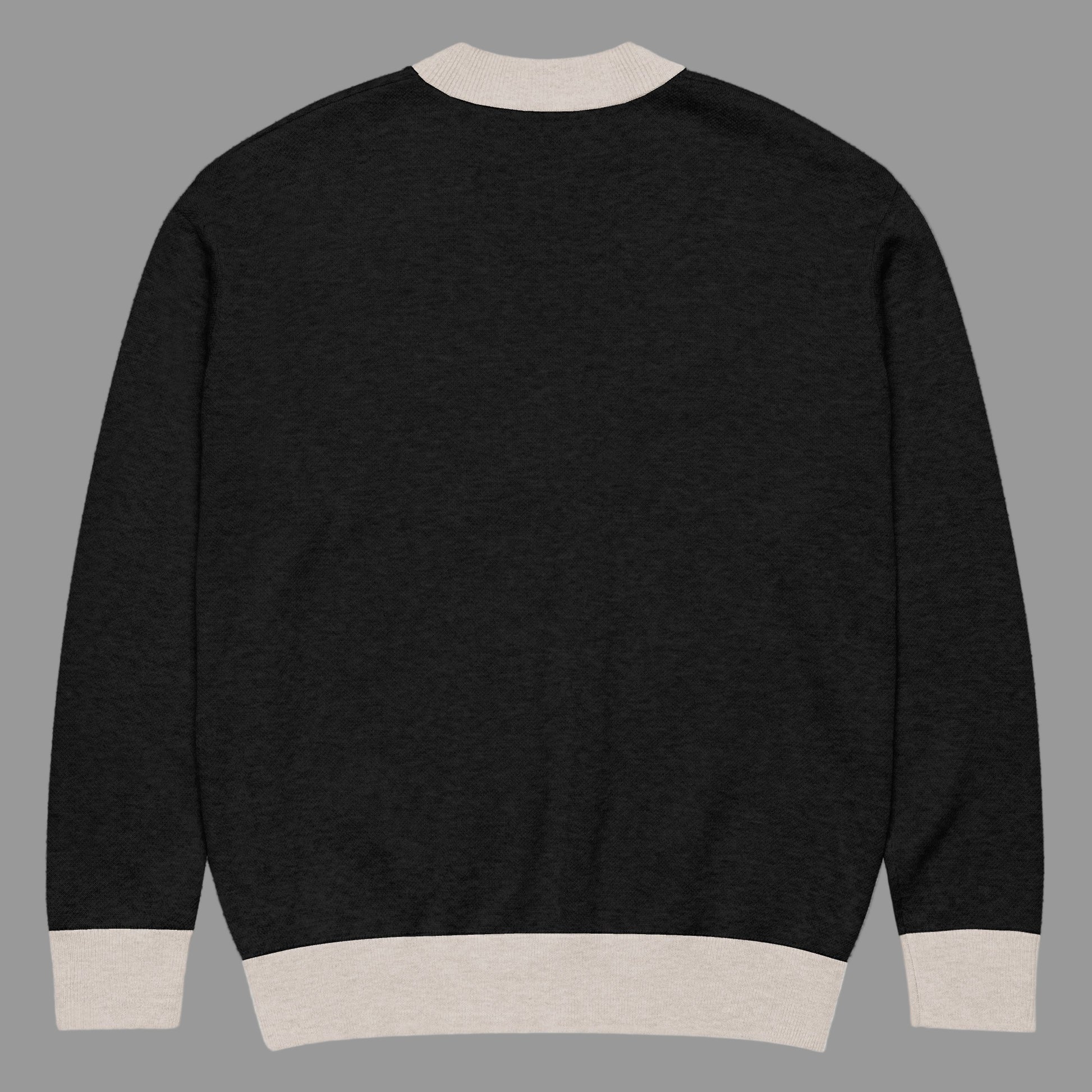 Black sweater with beige trim on a white background