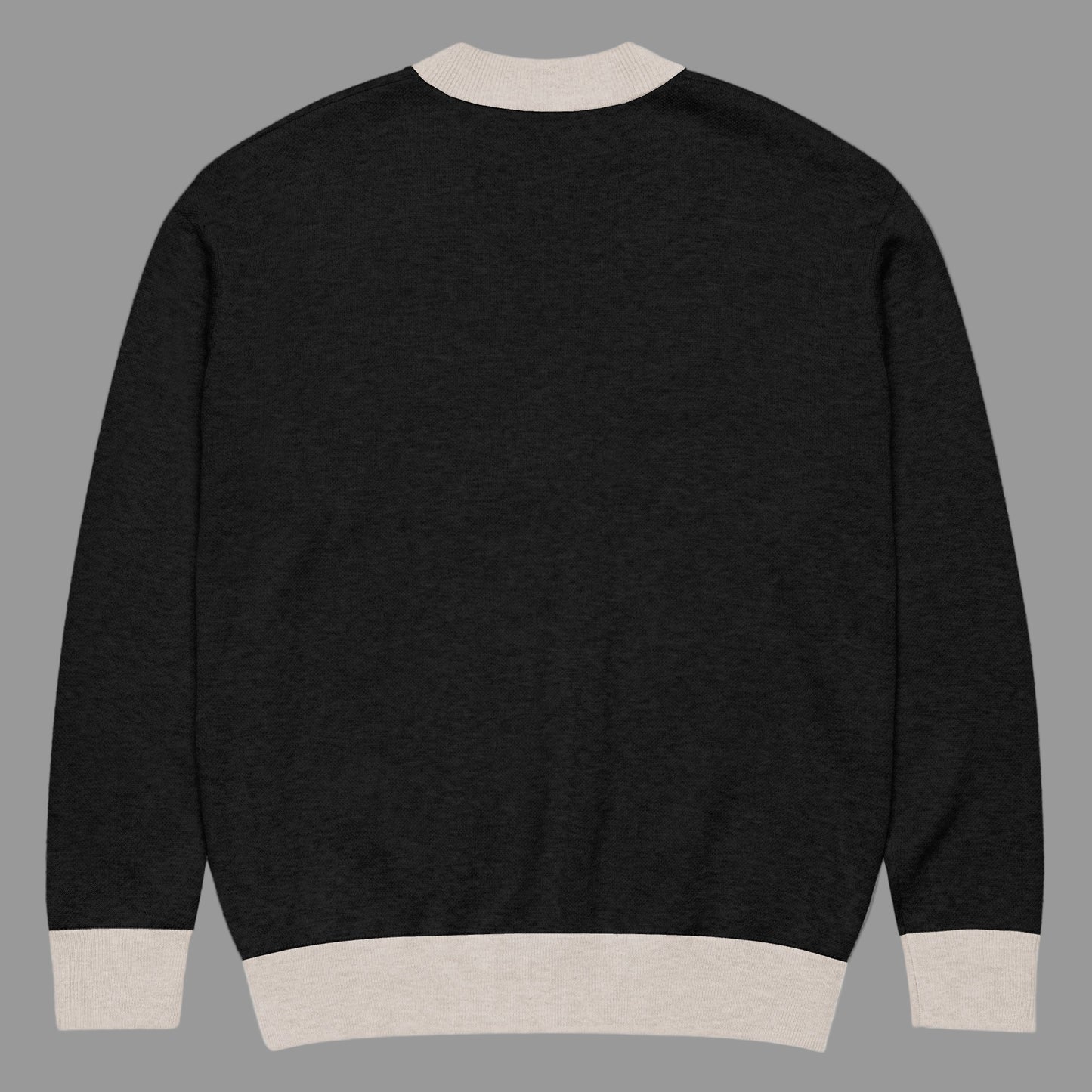 Black sweater with beige trim on a white background