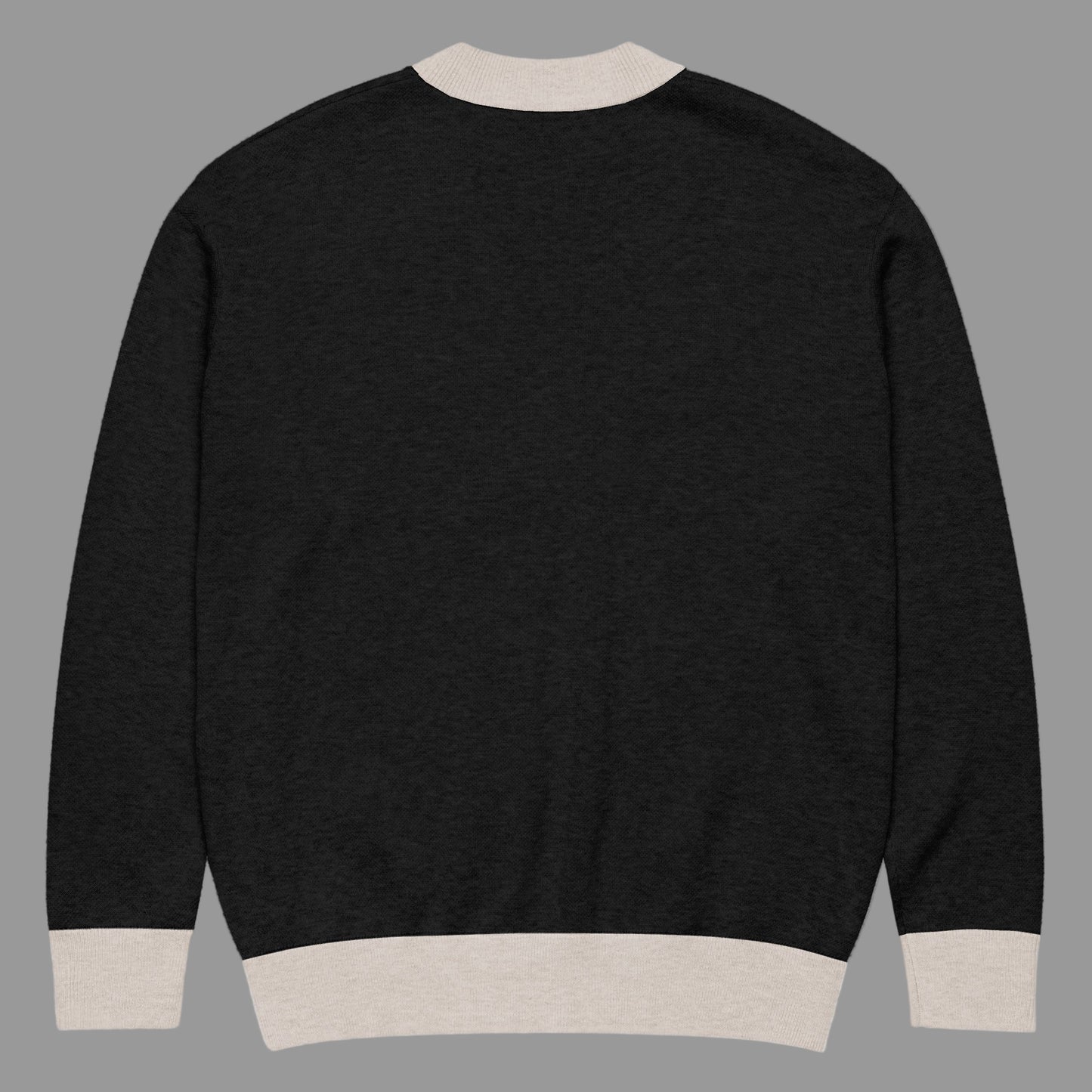 Black sweater with beige trim on a white background