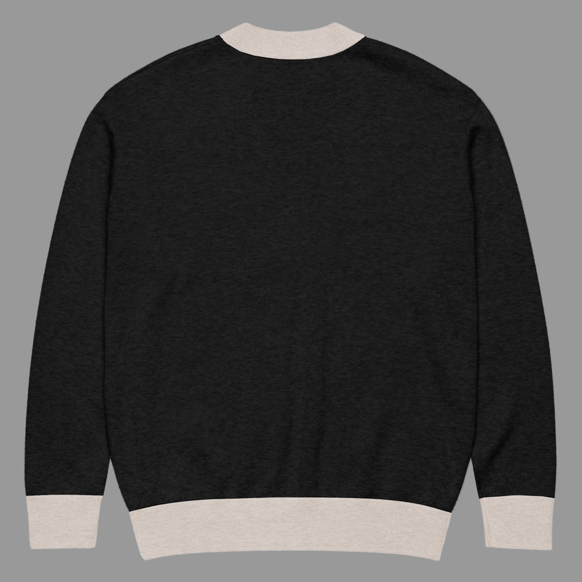 Black sweater with beige trim on a white background