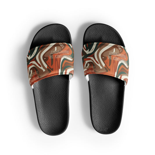 Pair of slides with a marbled pattern on the straps against a white background