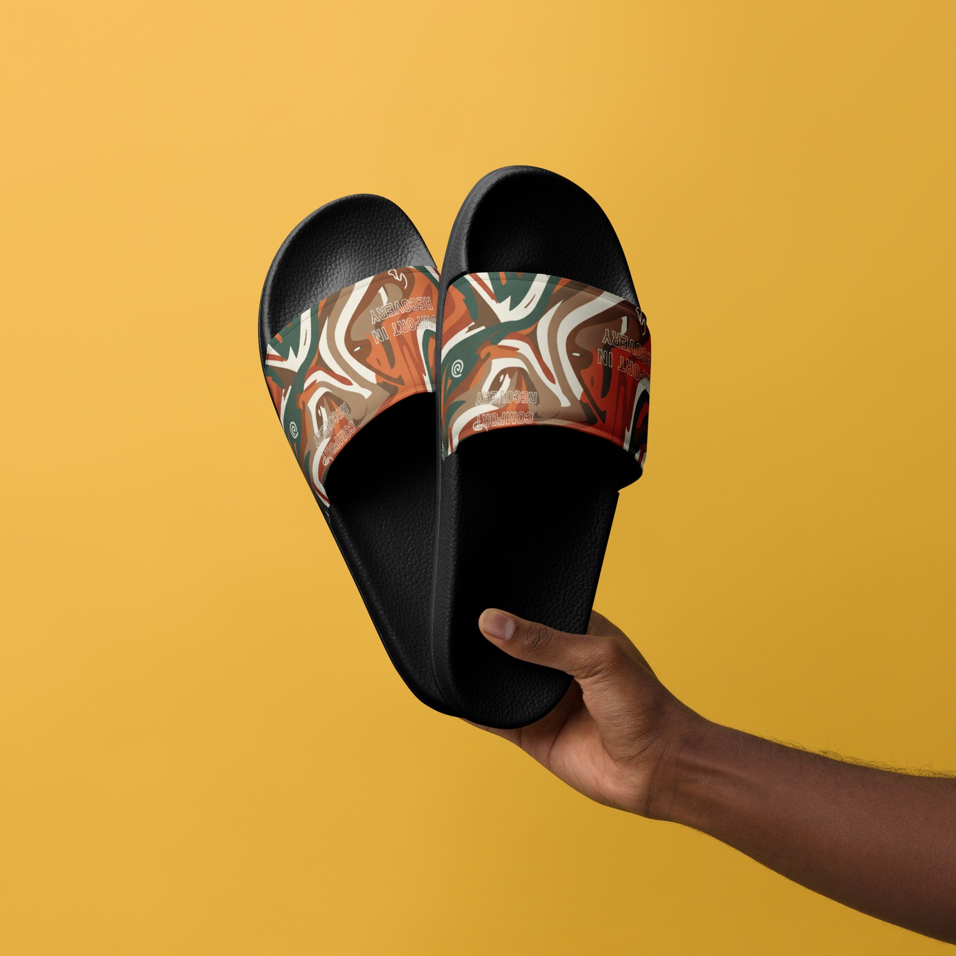 Black slides with a colorful pattern held by a hand against a yellow background