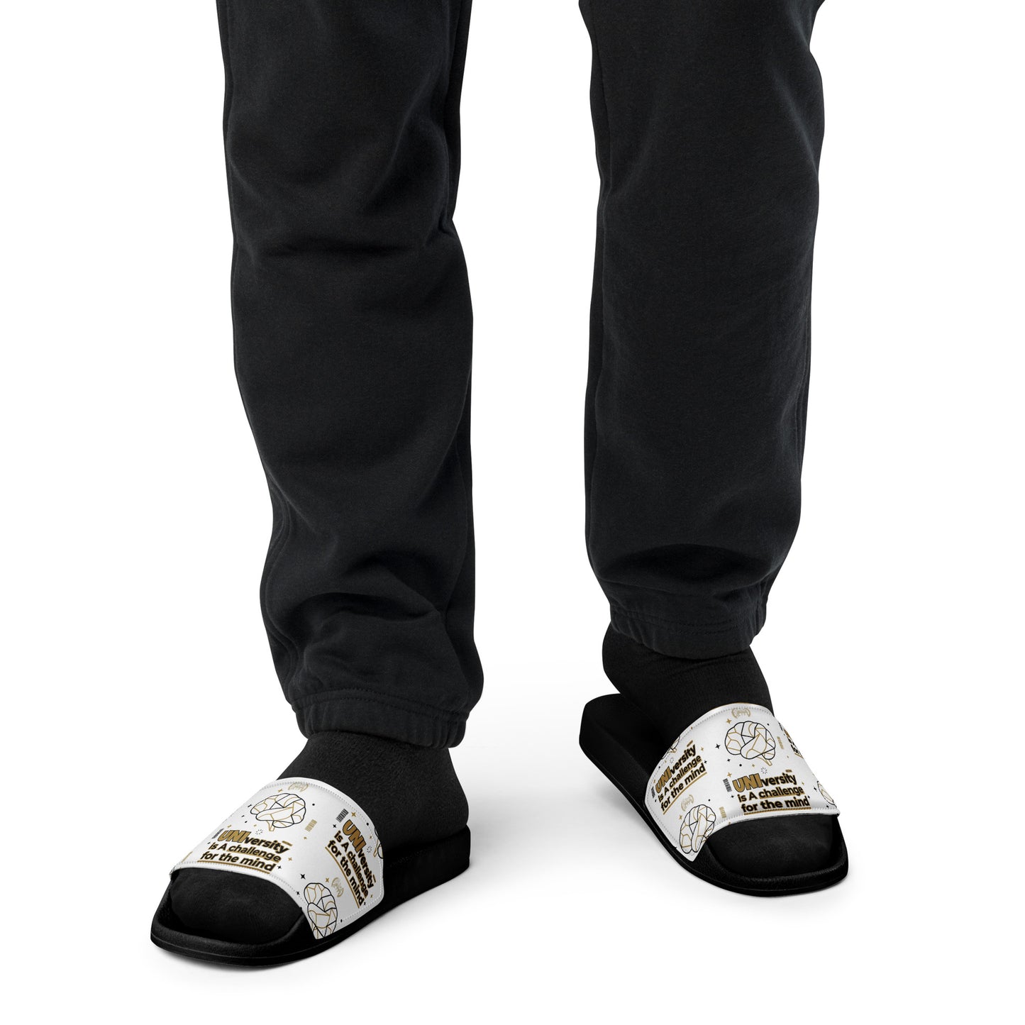 Black and white slippers worn with black pants on a white background