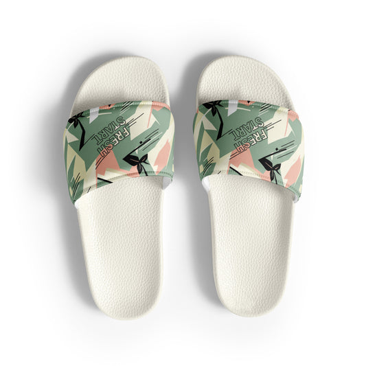 White slides with green floral straps on a white background
