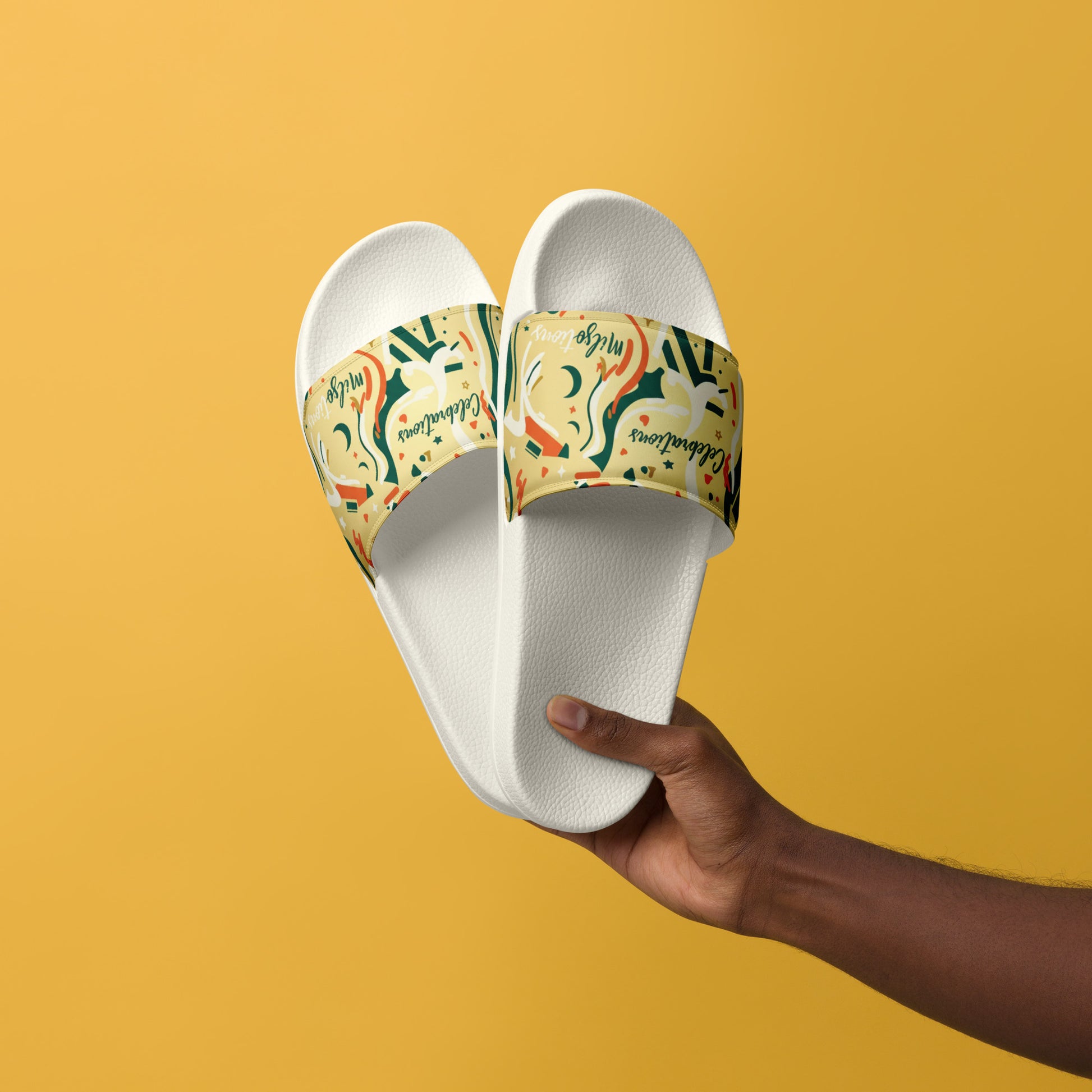 White slides with colorful strap held by a hand against a yellow background