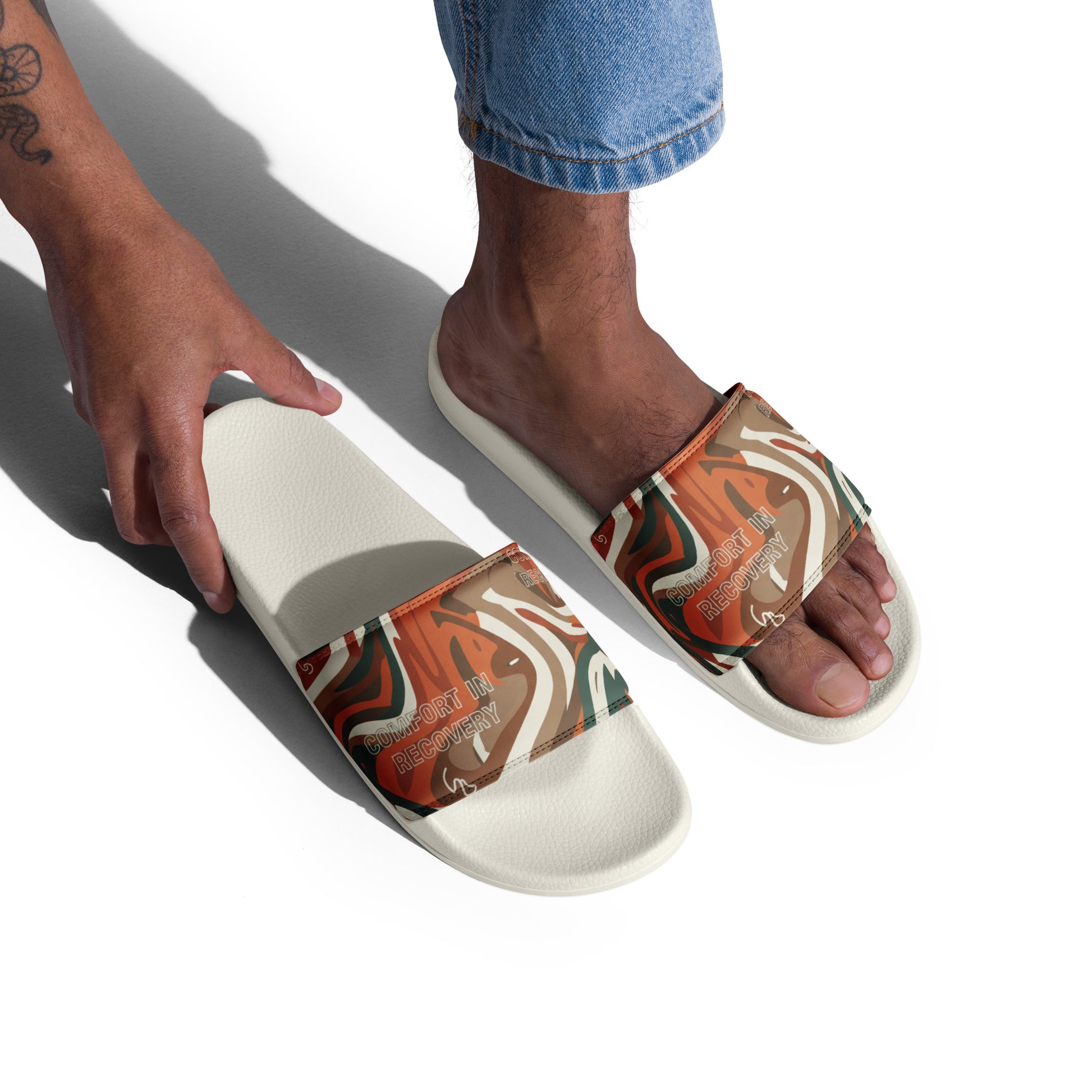 Person wearing a tan and white sandal on a white background