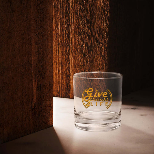 Clear glass with 'Give Thanks Life' engraving on a wooden surface