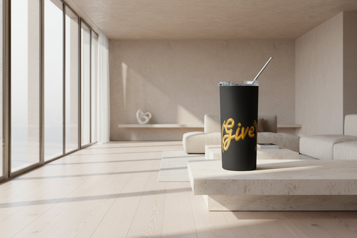 Black tumbler with gold text and a clear lid and metal straw on a white background