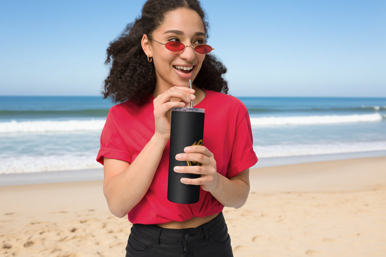 Person wearing a red shirt and sunglasses, holding a black tumbler with a straw.
