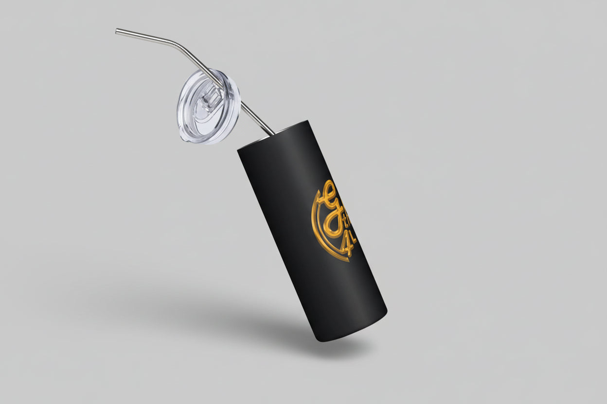 Black tumbler with gold logo and straw on a white background