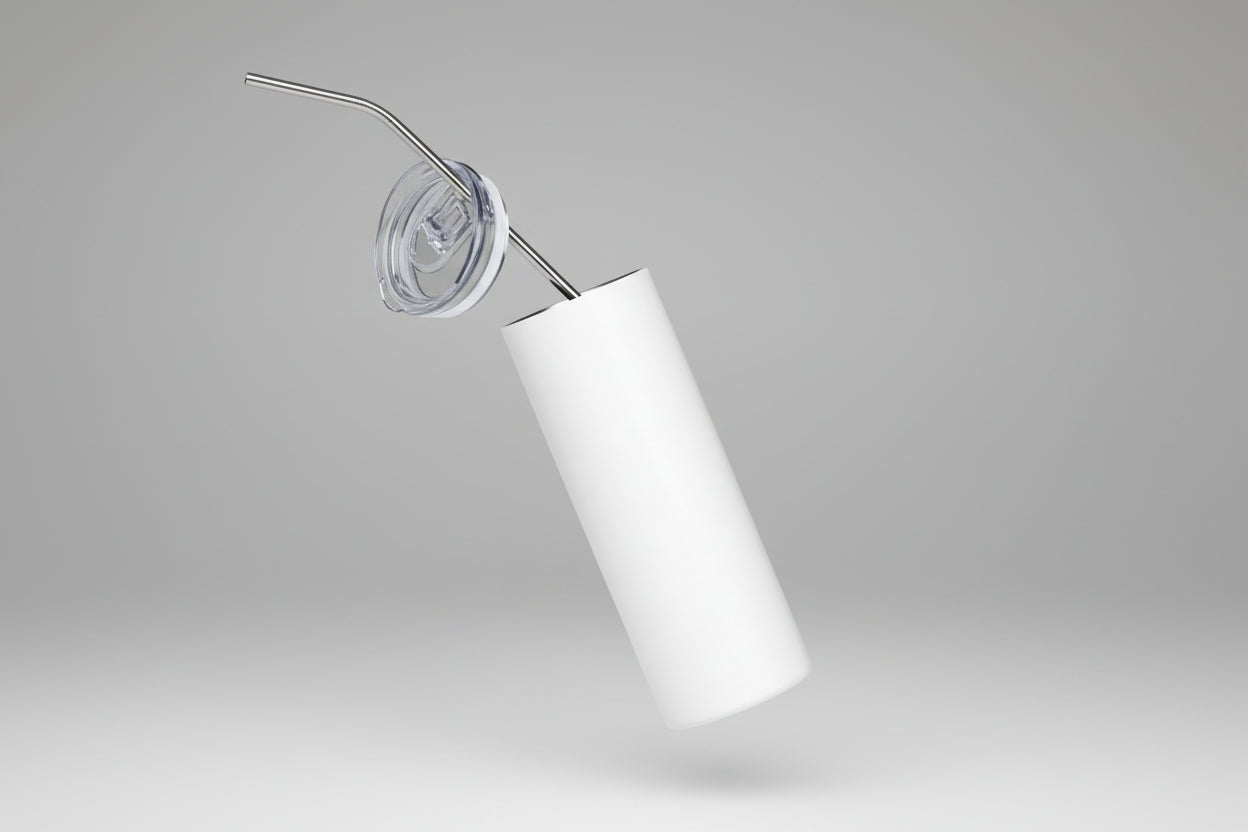 White tumbler with a metal straw on a white background