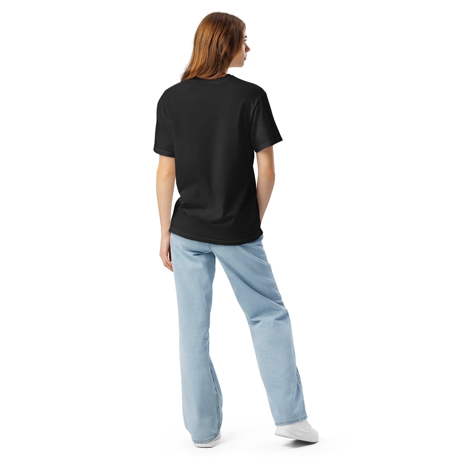 Person wearing a black t-shirt and light blue jeans on a white background