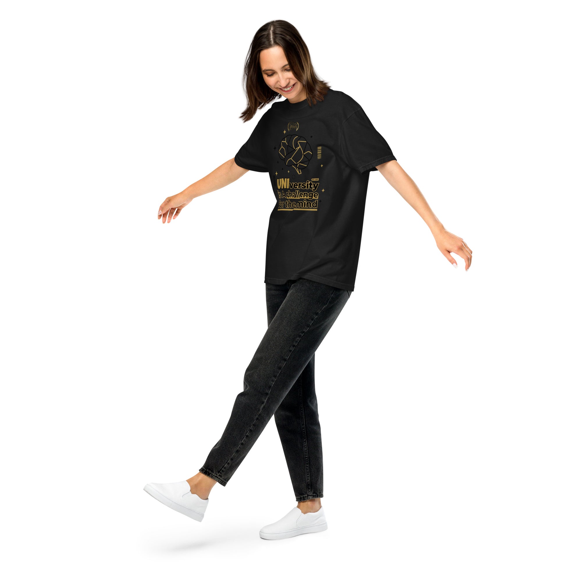 Woman wearing a black t-shirt with text, black jeans, and white sneakers on a white background