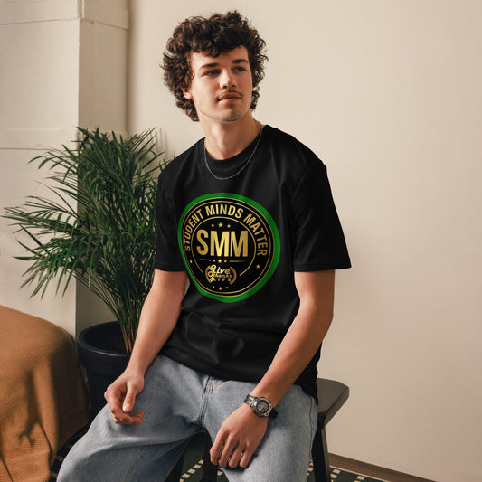 Person wearing a black t-shirt with a graphic design sitting indoors.