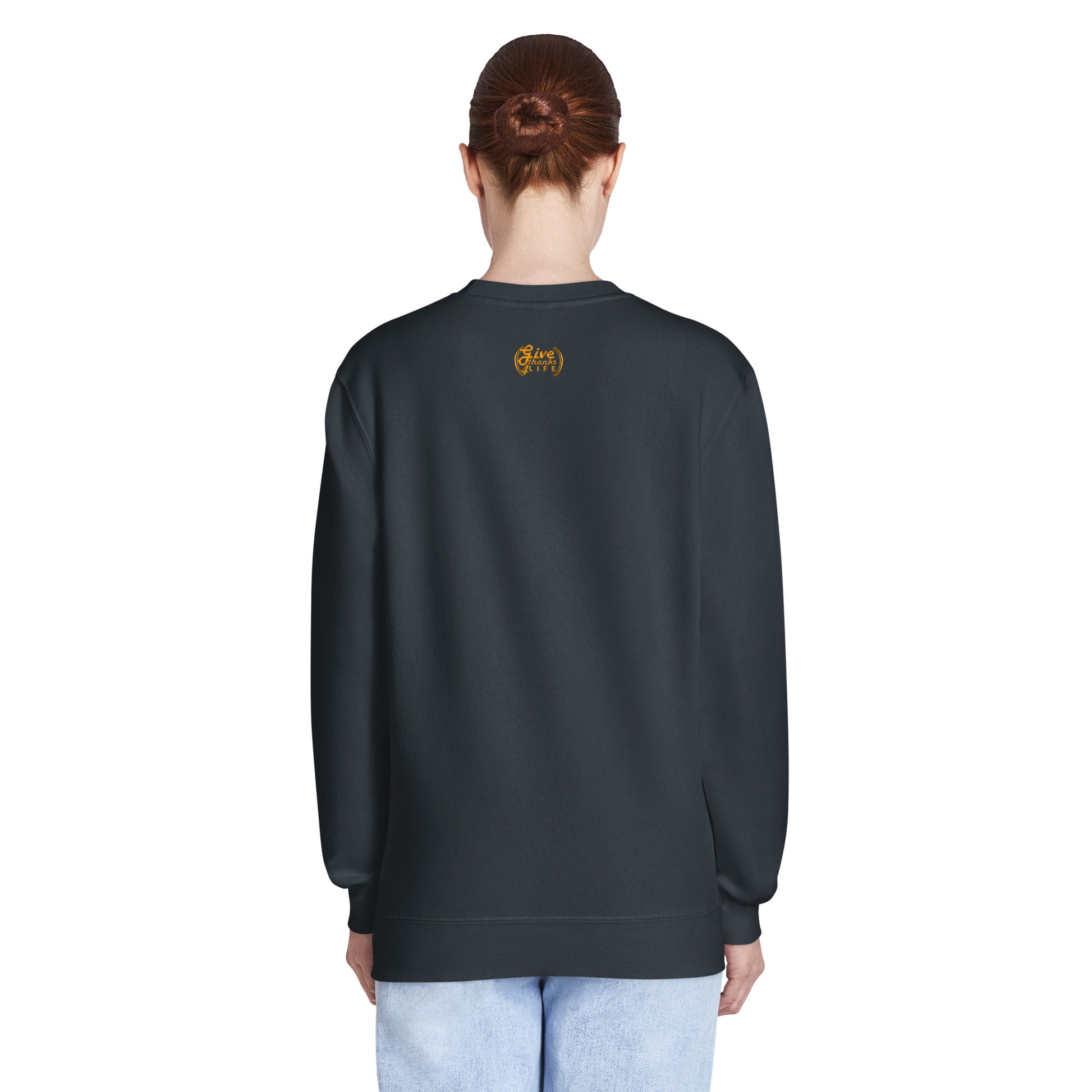 Person wearing a dark gray sweatshirt with text on the back, standing against a white background