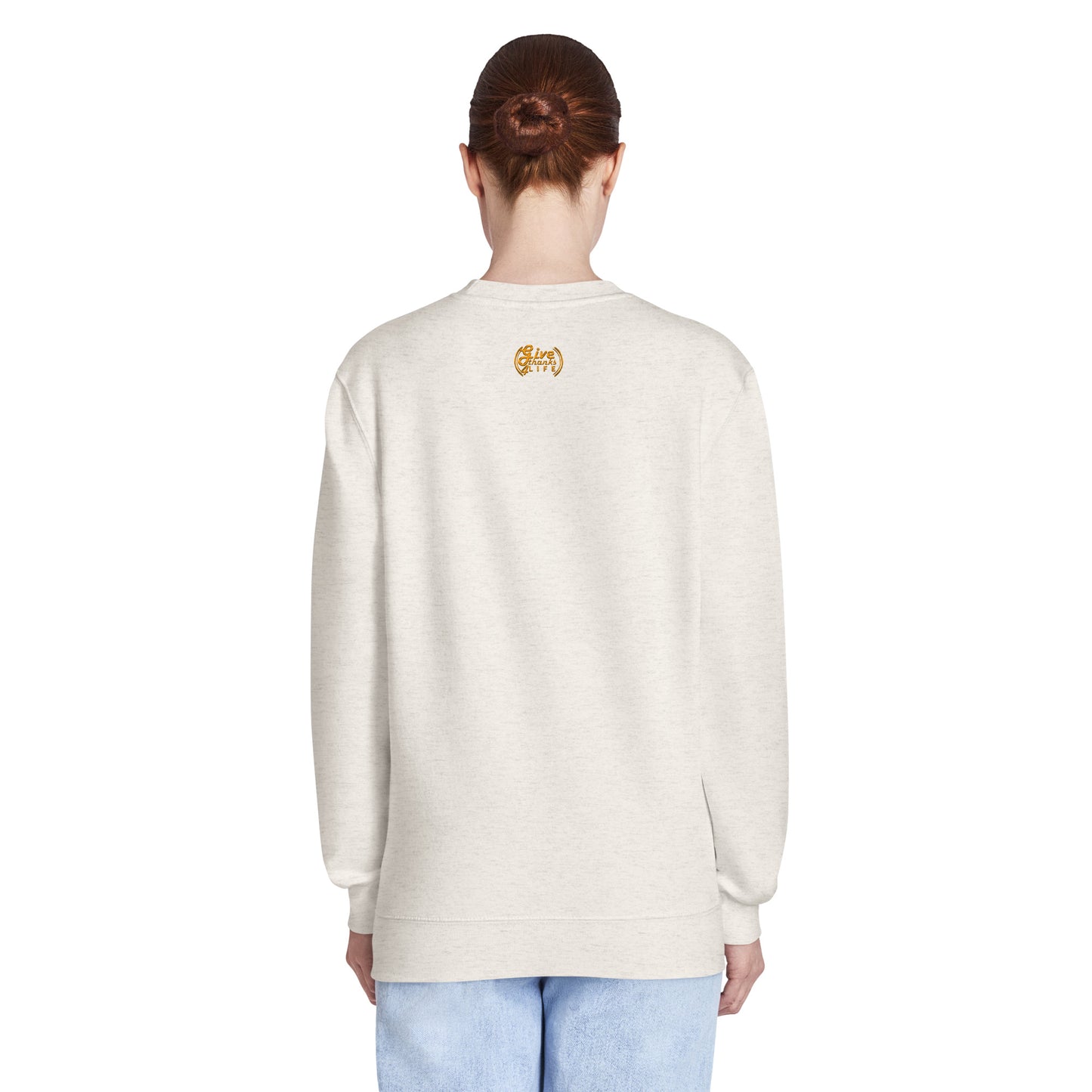 Person wearing a light-colored sweatshirt with a logo on the back against a white background