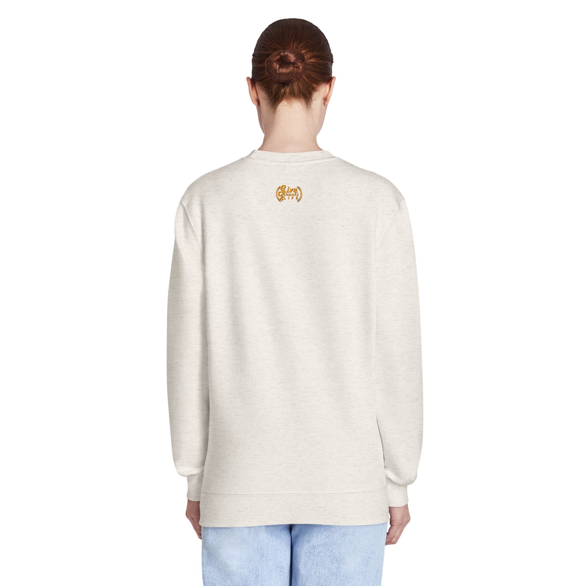 Person wearing a light-colored sweatshirt with a logo on the back against a white background