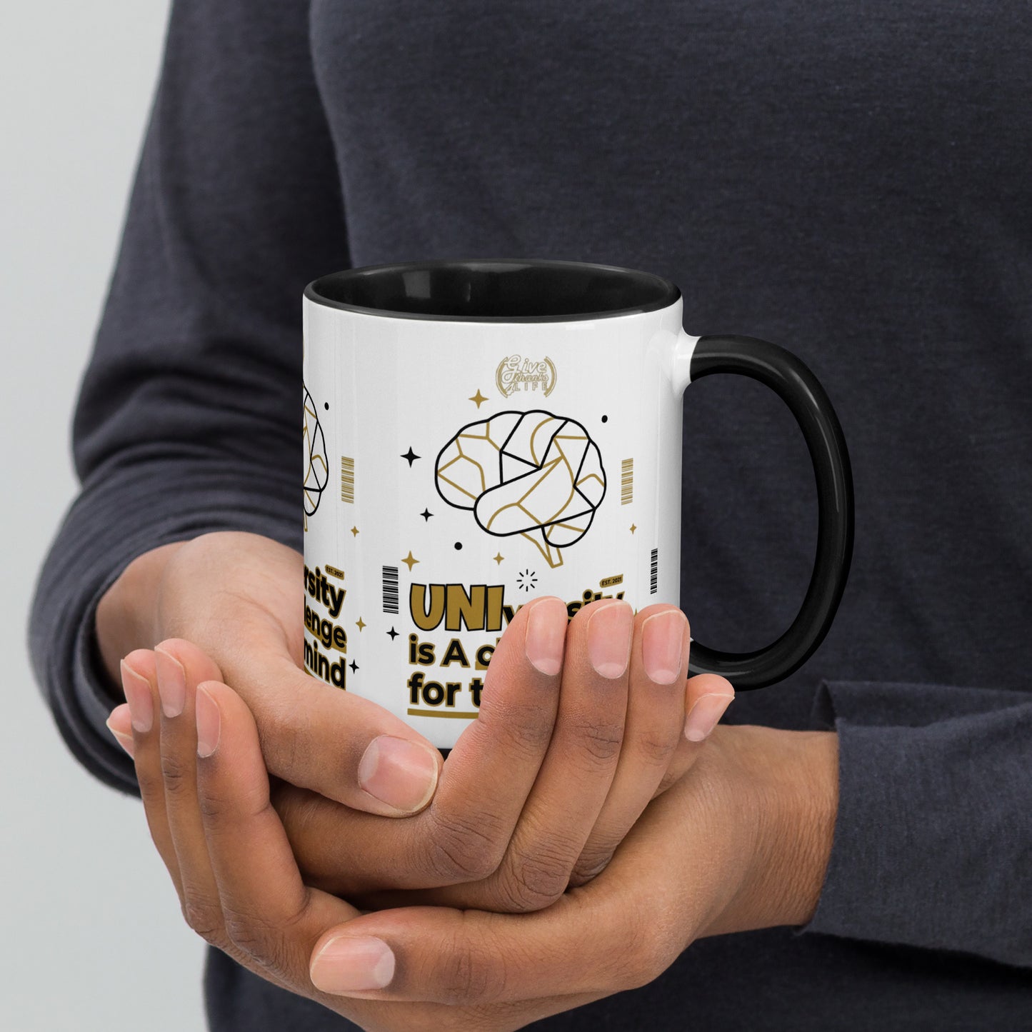 Person holding a mug with a design on a plain background