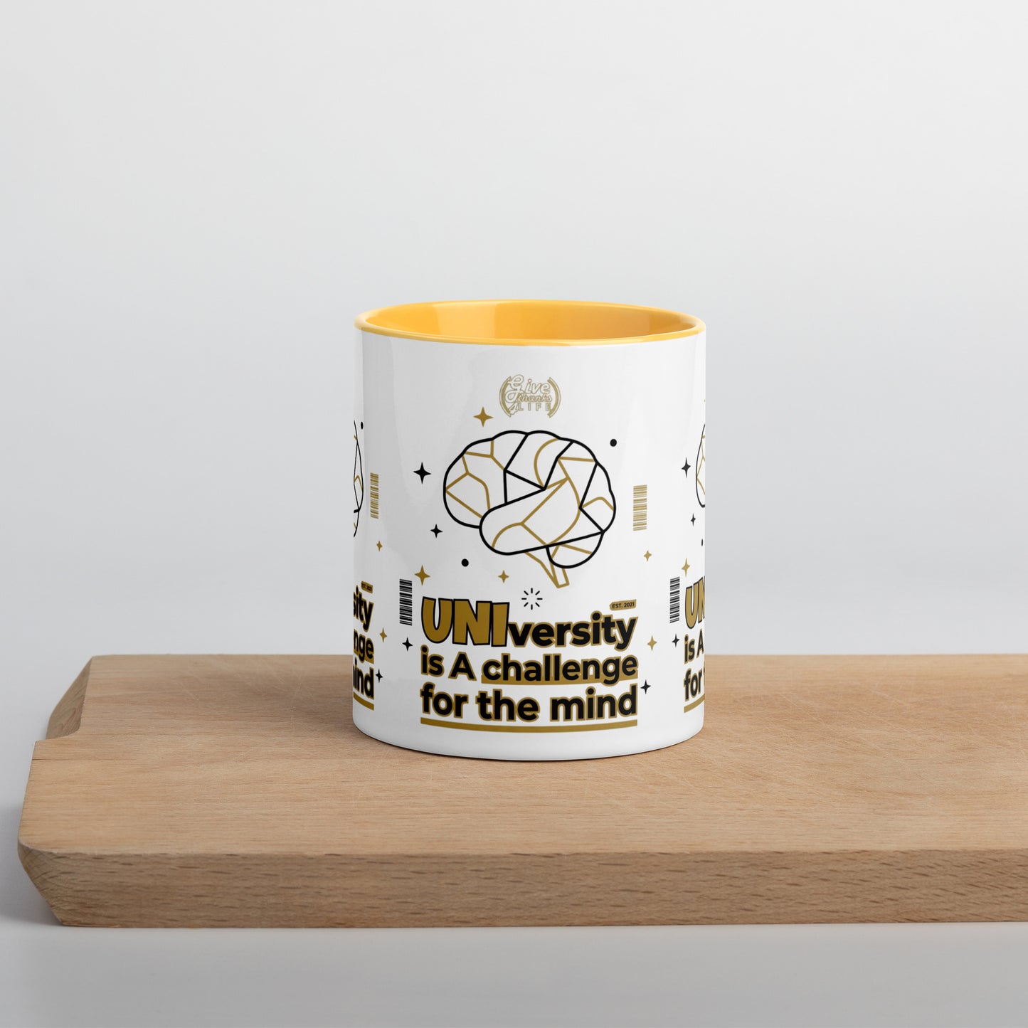 White mug with yellow interior on a wooden surface and light gray background