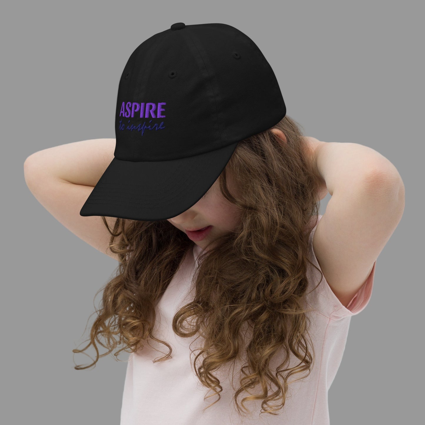 Young Girl Wearing Aspire to inspire Black Baseball Cap Left Front