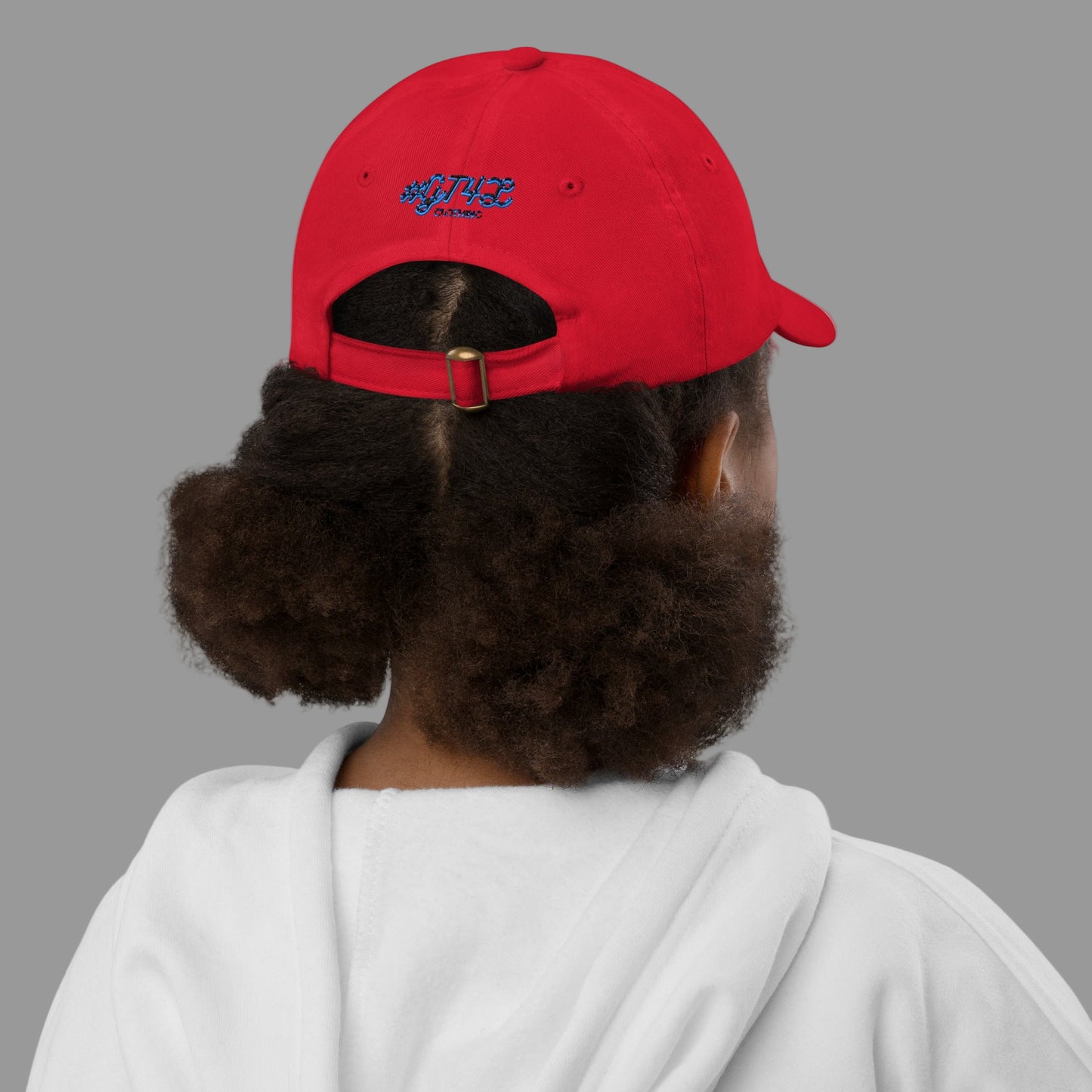 Person wearing a red cap with a logo on the back, on a white background