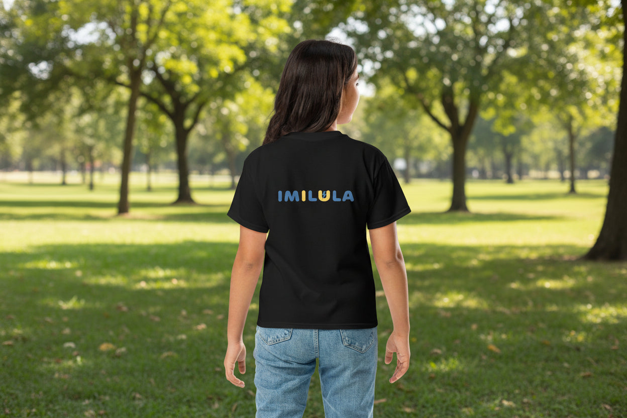 Girl looking at birds in the park, wearing an IMILULA BLACK T-Shirt