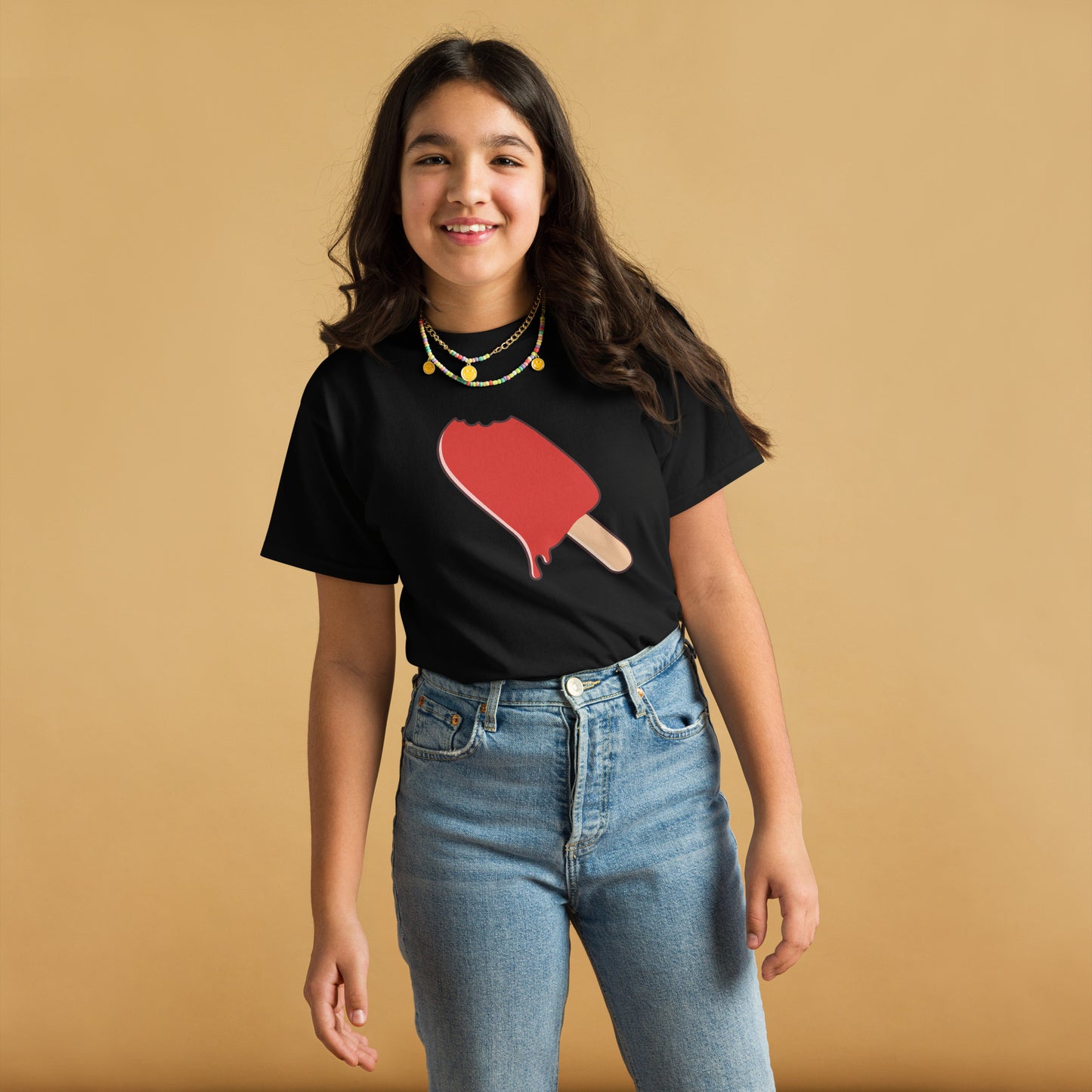 Person wearing a black t-shirt with a red heart and paddle graphic on a beige background