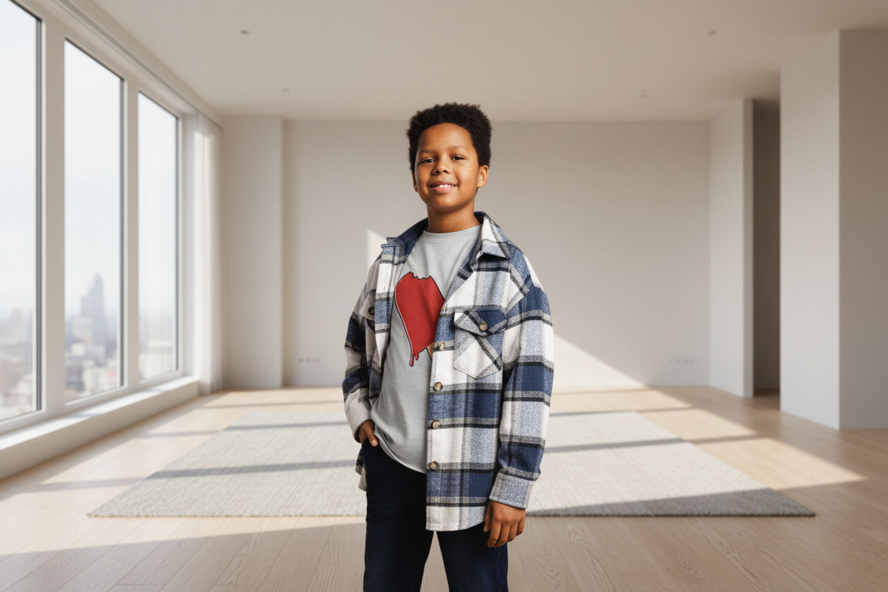 Child wearing a plaid shirt over a gray t-shirt with a red graphic on a striped background