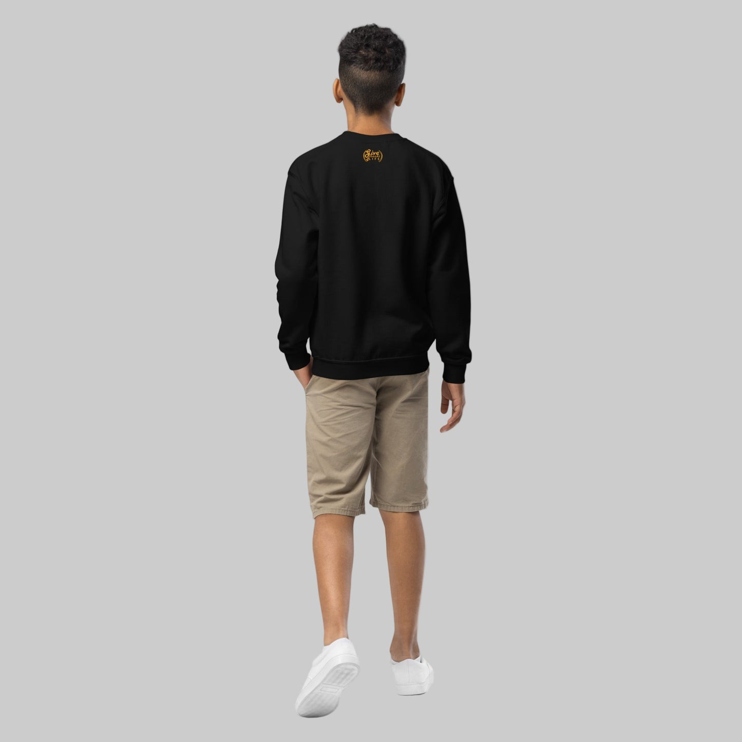 Person wearing a black sweatshirt with a logo on the back, standing against a white background