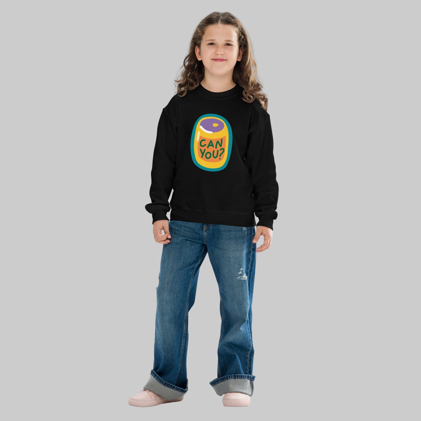 Child wearing a black sweatshirt with a colorful graphic design on a white background