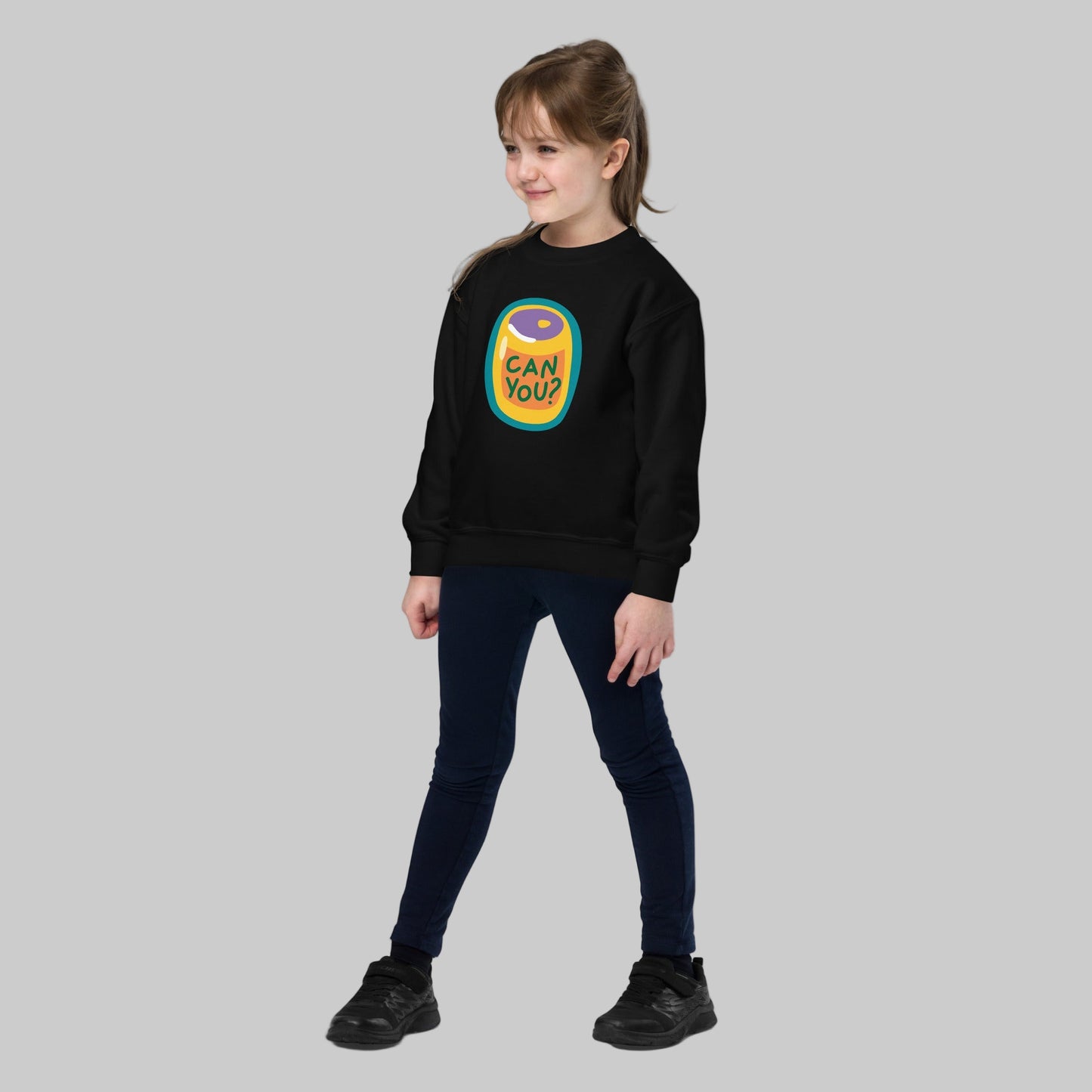 Child wearing a black sweatshirt with a colorful graphic design on a white background