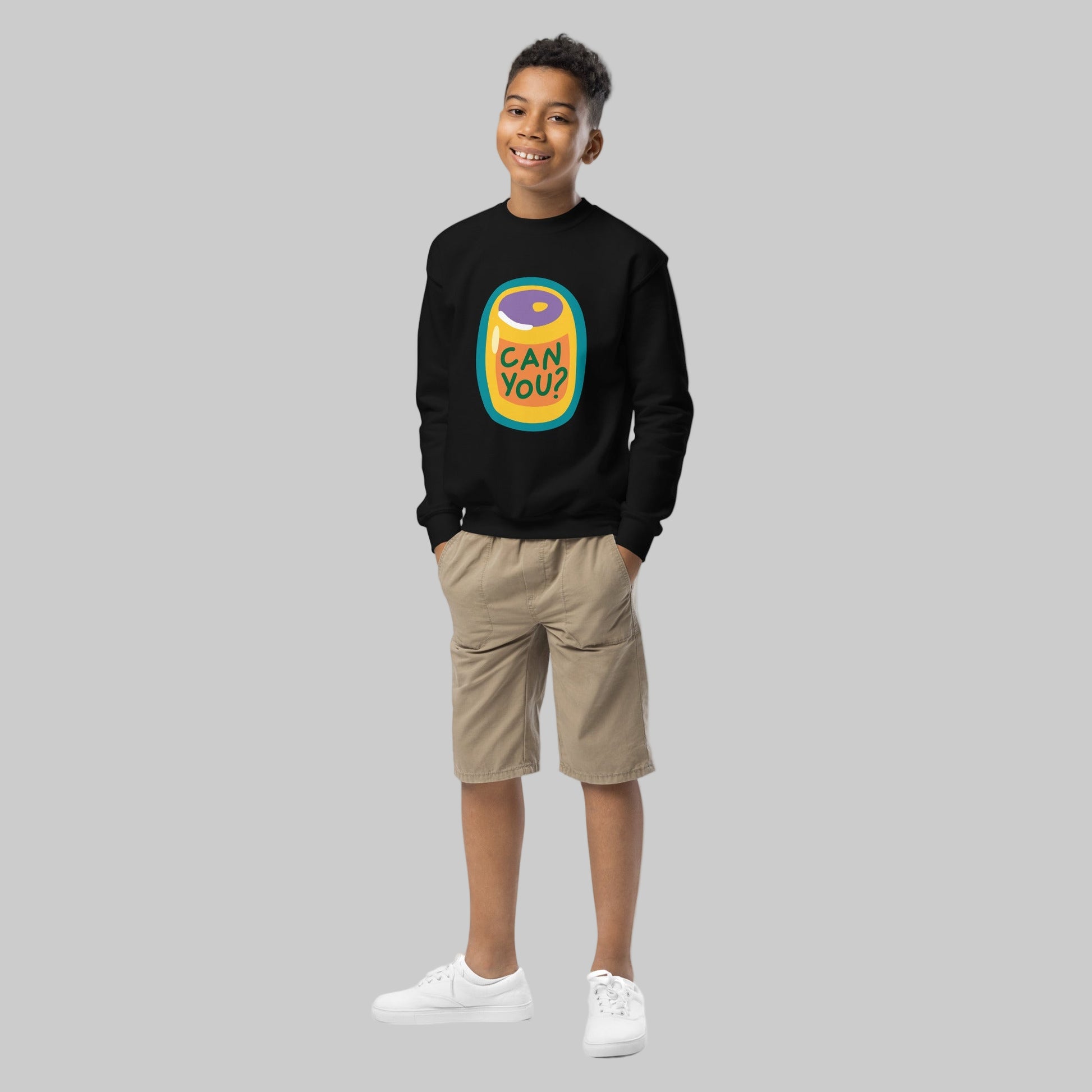 Child wearing a black sweatshirt with a colorful graphic and text on a white background