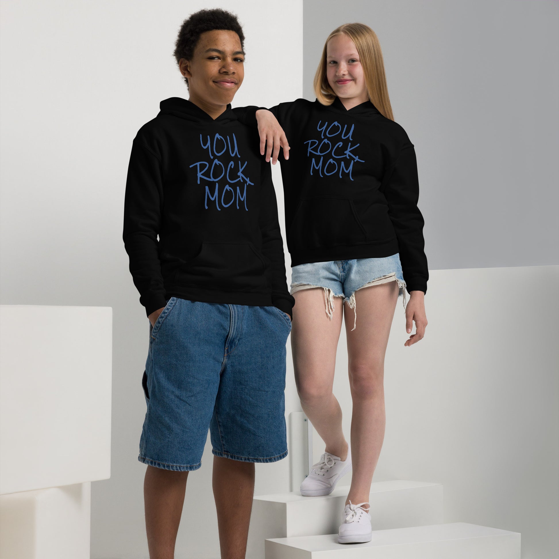 Two children wearing black hoodies with 'YOU ROCK MOM' text on a white background