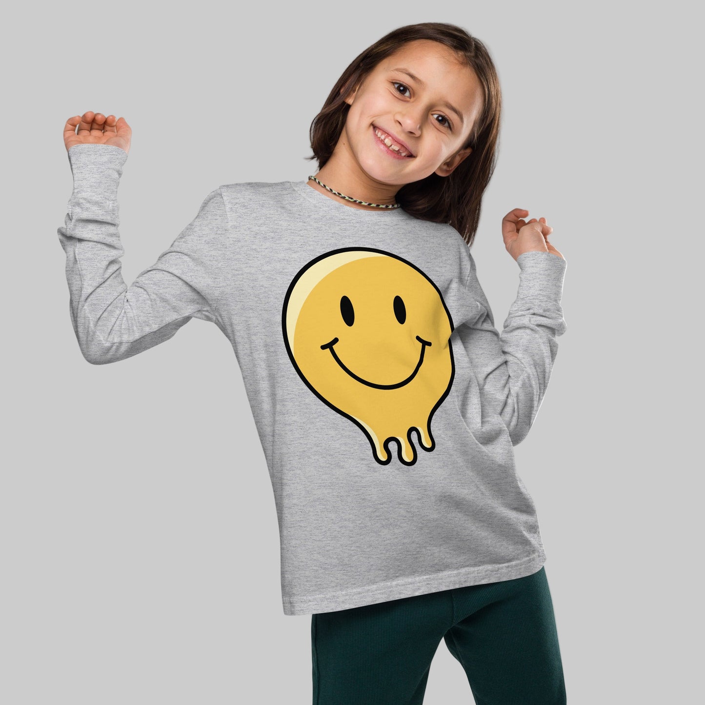 Child wearing a gray long-sleeve shirt with a yellow smiley face design on a white background