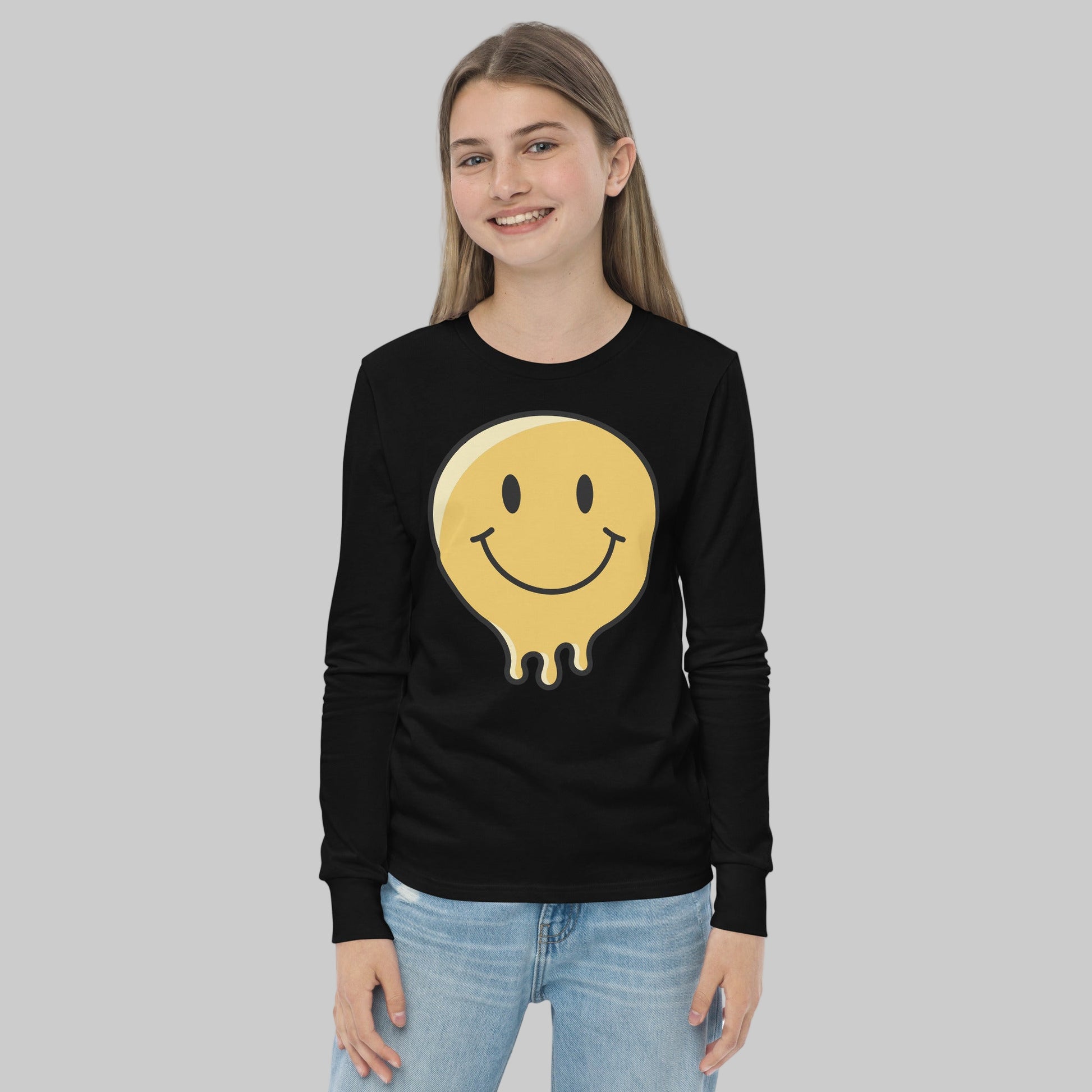 Person wearing a black long-sleeve shirt with a smiley face design on a white background