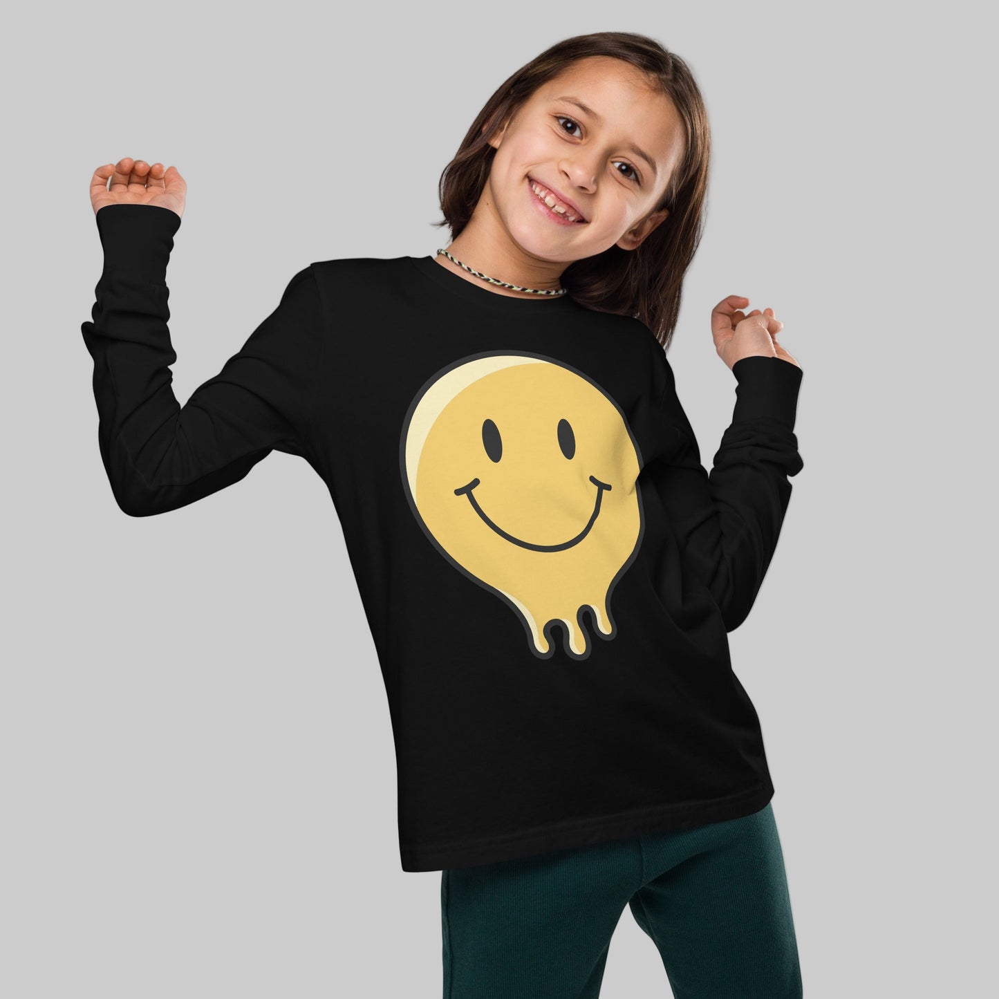 Child wearing a black long-sleeve shirt with a yellow smiley face design on a plain background