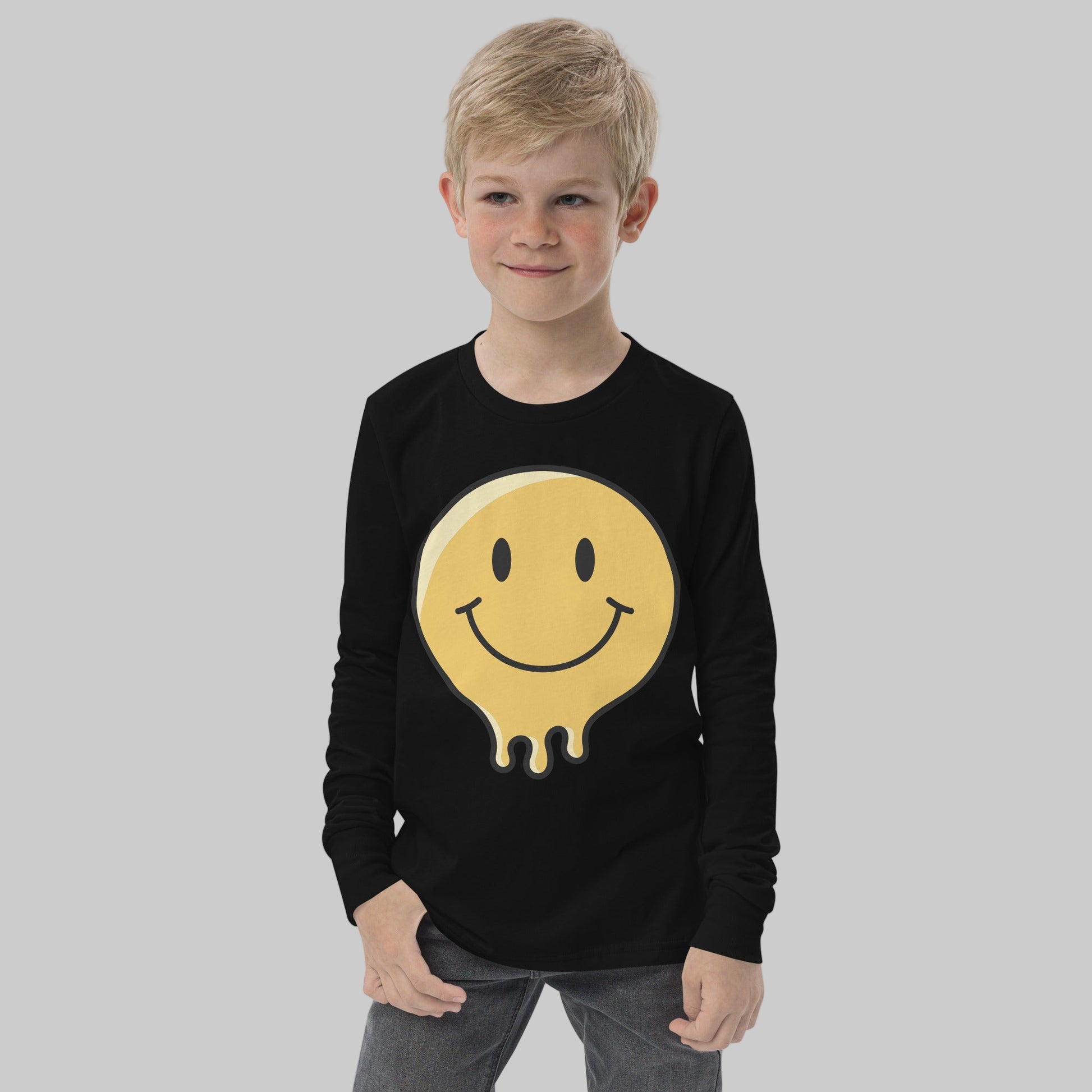 Child wearing a black long-sleeve shirt with a yellow smiley face design on a white background