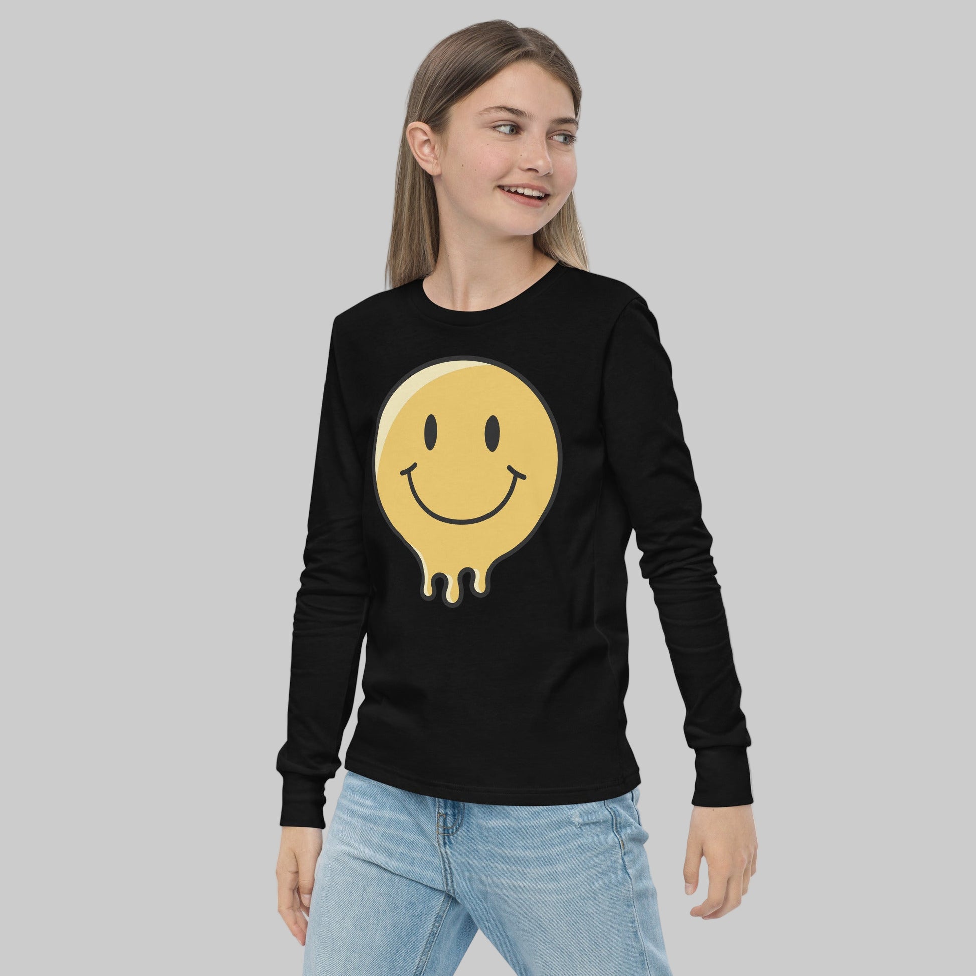 Person wearing a black long-sleeve shirt with a yellow smiley face design on a white background