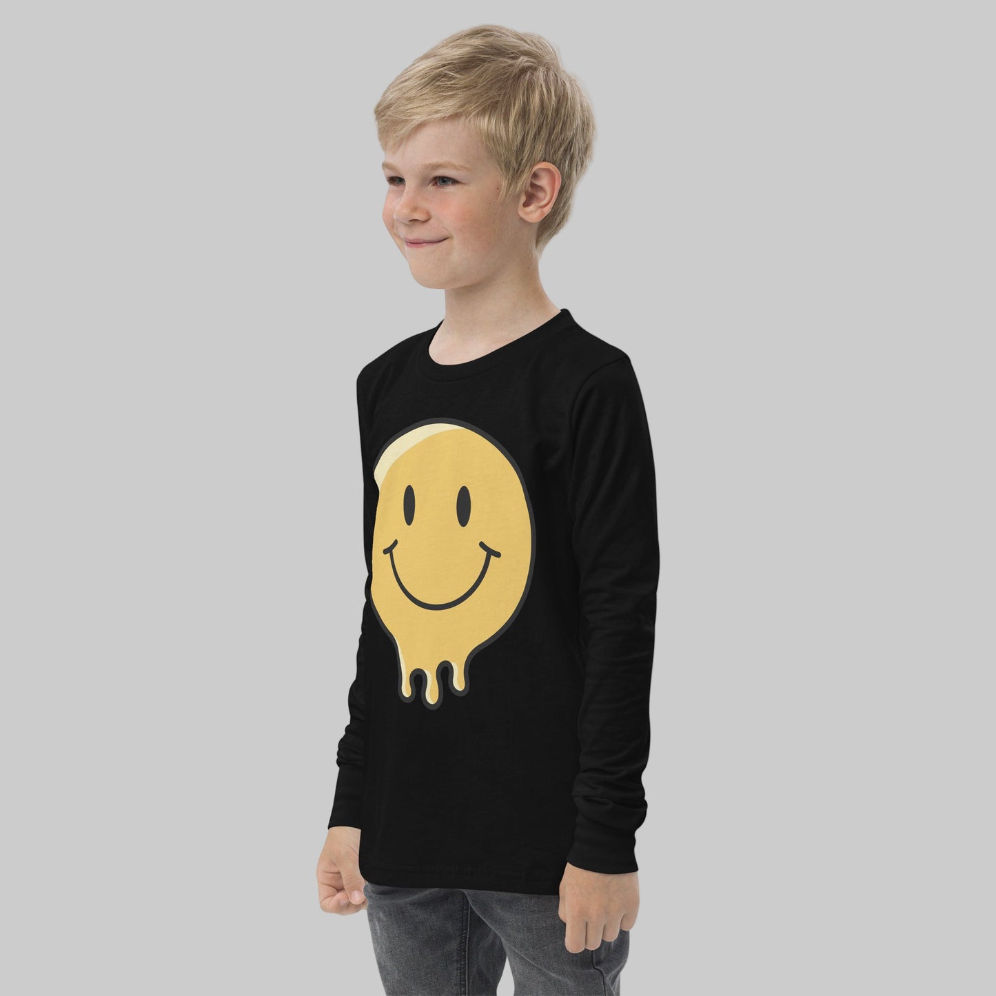 Child wearing a black long-sleeve shirt with a yellow smiley face design on a white background