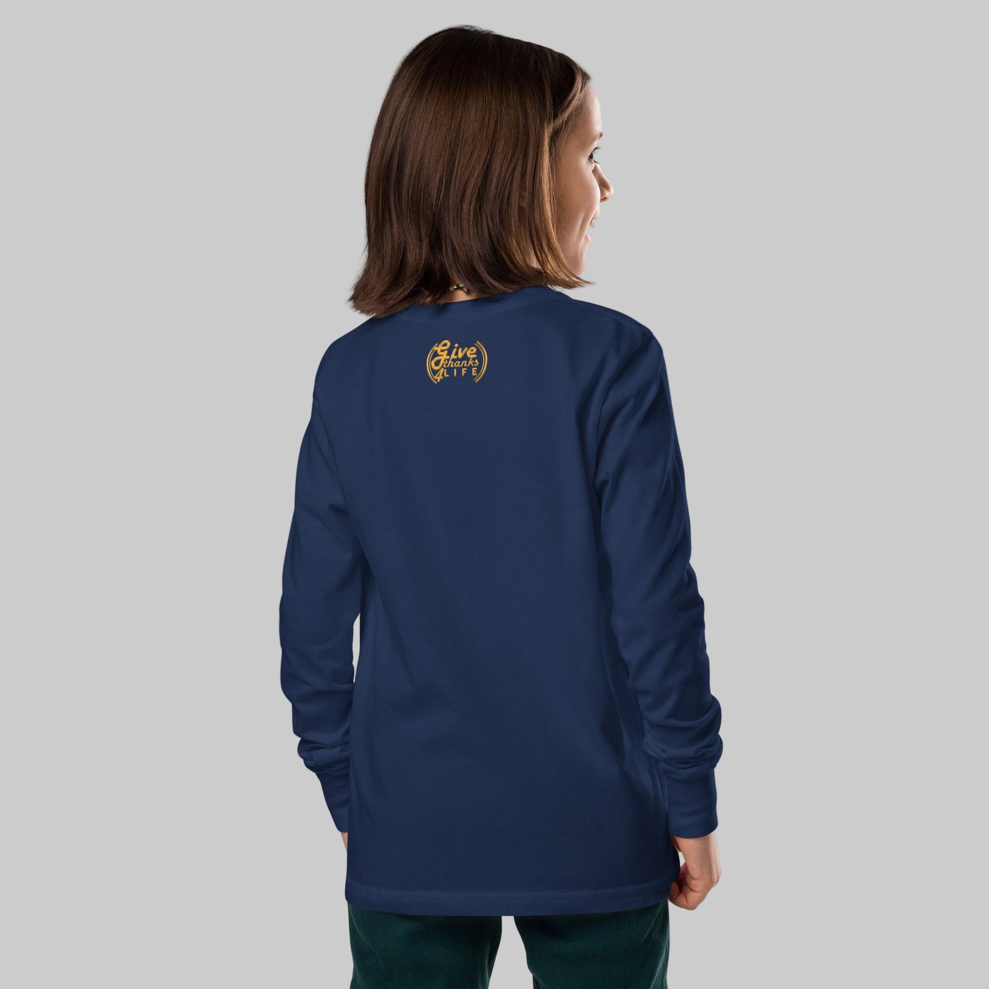 Person wearing a blue long-sleeve shirt with a logo on the back, standing against a white background