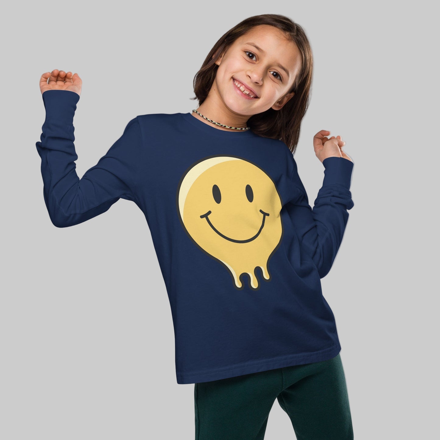 Child wearing a navy blue long-sleeve shirt with a yellow smiley face design on a white background