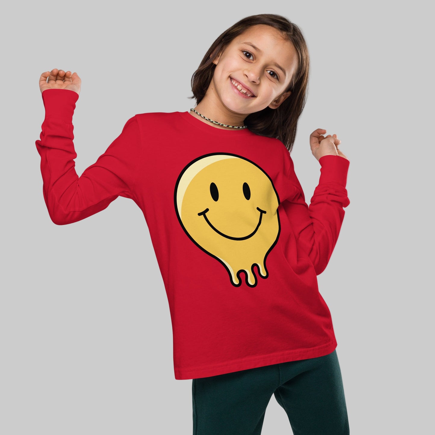 Child wearing a red long-sleeve shirt with a yellow smiley face design on a white background