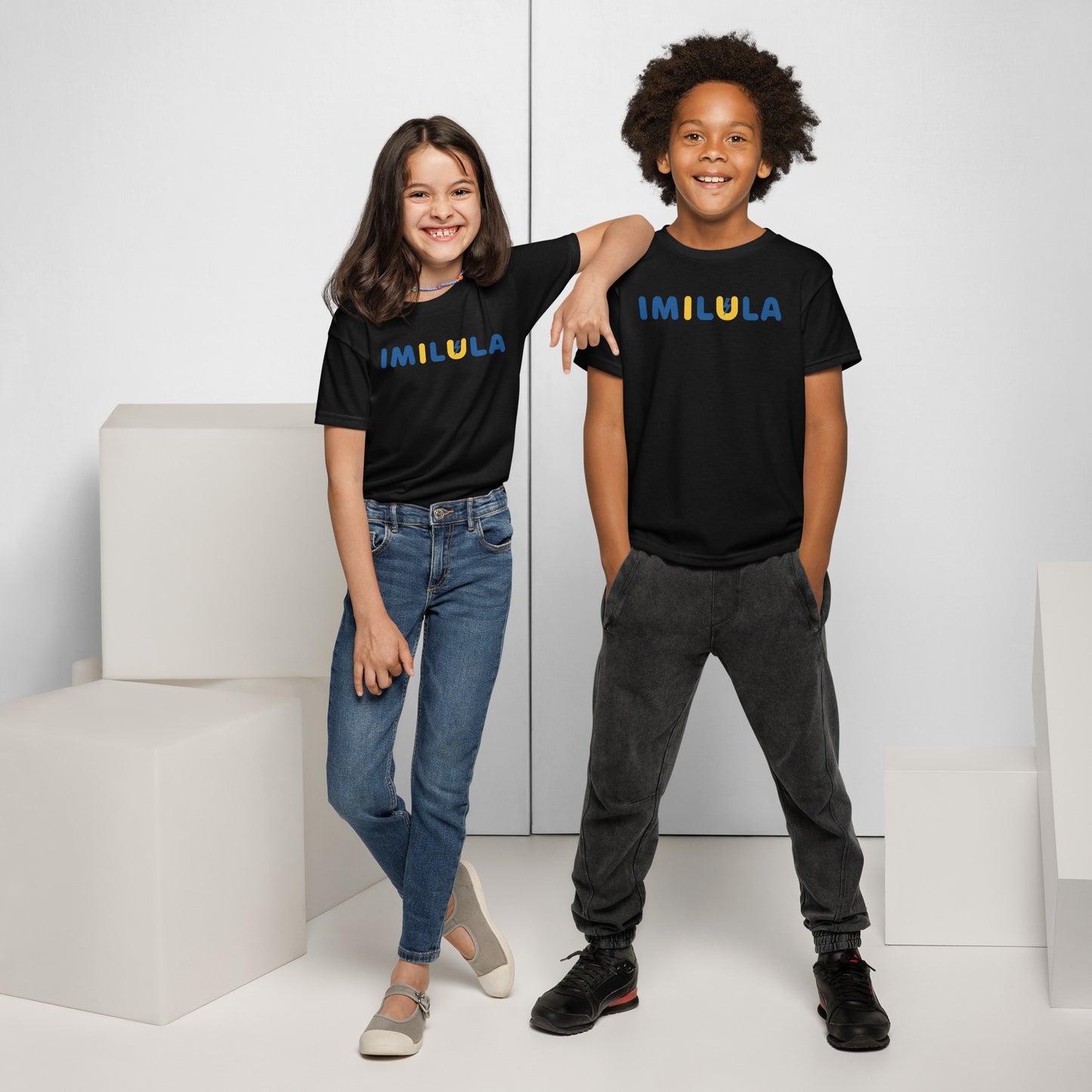 Two children wearing black t-shirts with colorful designs, standing against a white background.