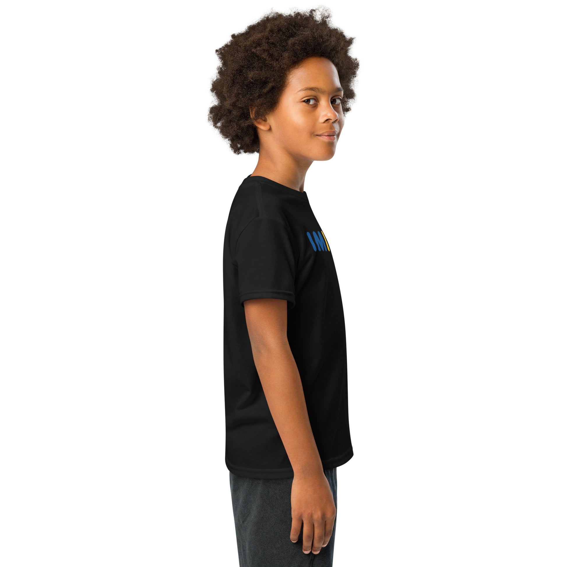 Child wearing a black t-shirt with small designs on a white background