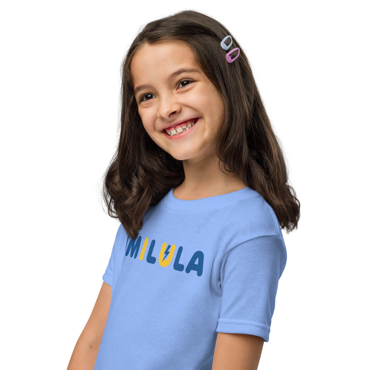 Young girl wearing a blue t-shirt with 'MILULA' printed on it against a white background