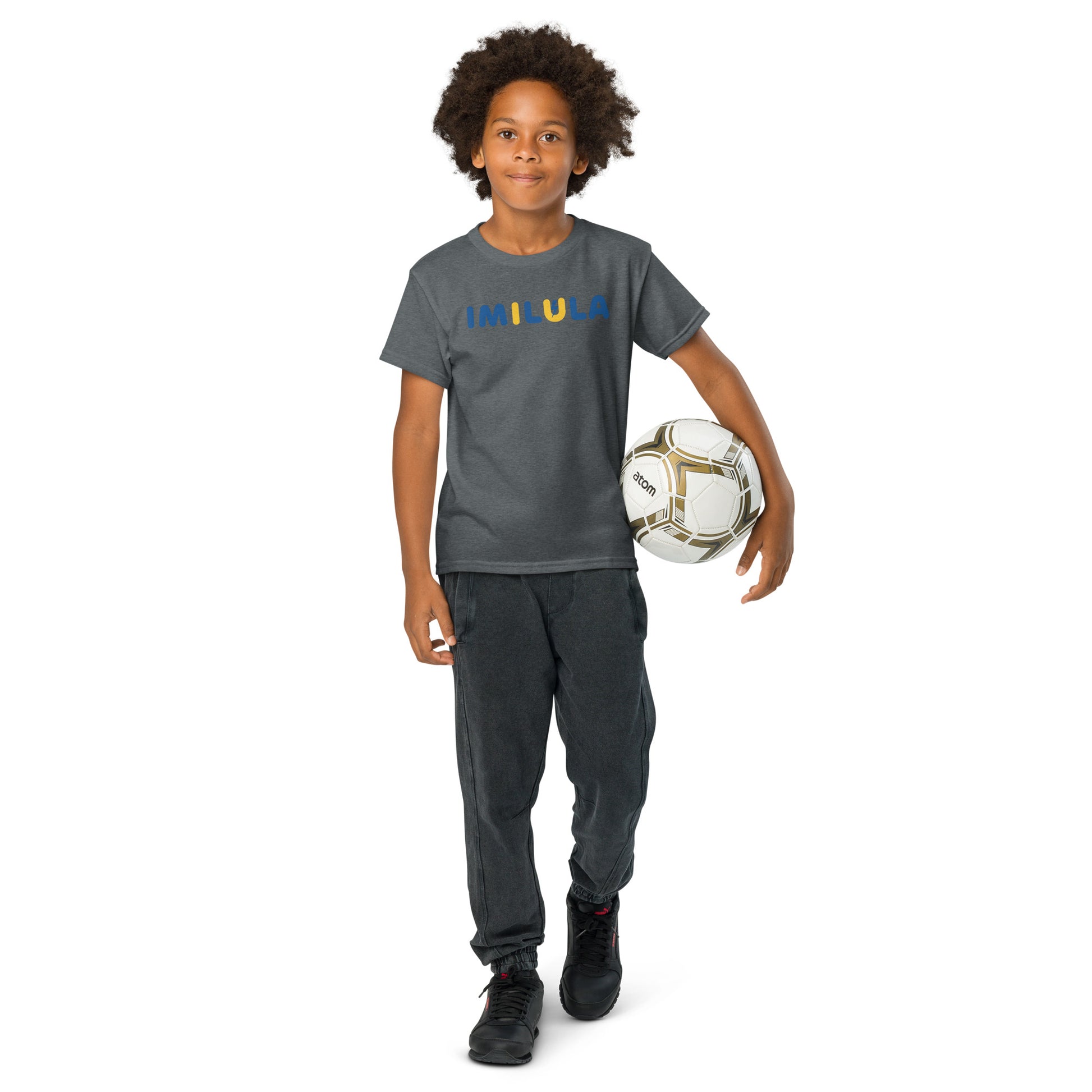 Child wearing a gray 'Faith Family Football' t-shirt and holding a soccer ball on a white background